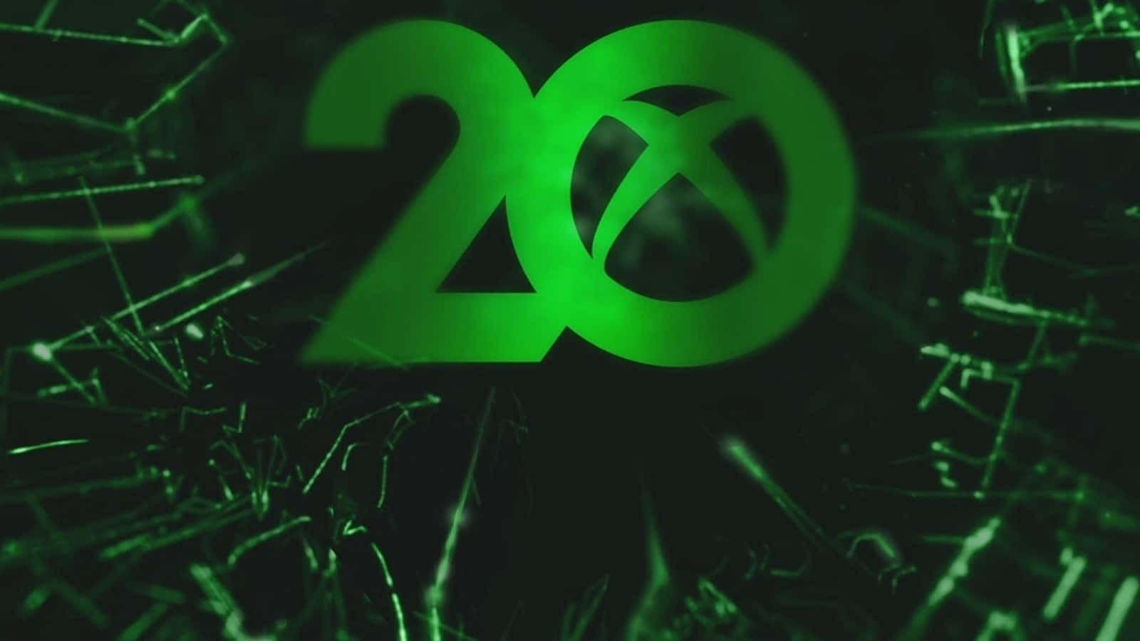 碎裂玻璃紋理後方的發光綠色Xbox 20標誌。