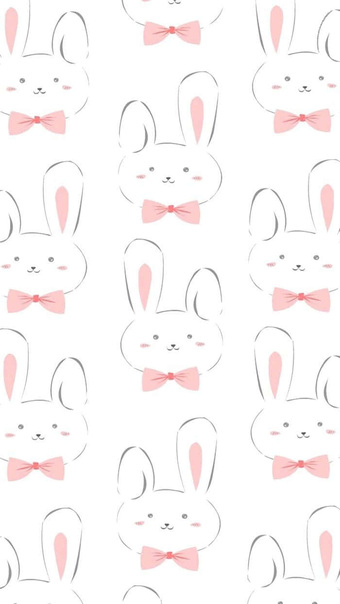Kawaii Bunny 桌布 壁紙 — 在乾淨的白色背景上，可愛卡通兔子戴著粉紅色蝴蝶結的重複圖案。