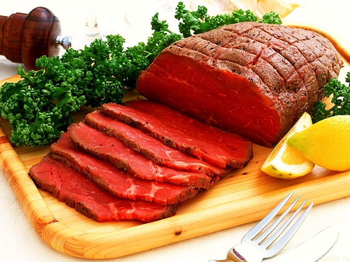 Red Meat 桌布 壁紙 — 在木砧板上切片嘅稀有烤牛肉，配新鮮歐芹同檸檬角。