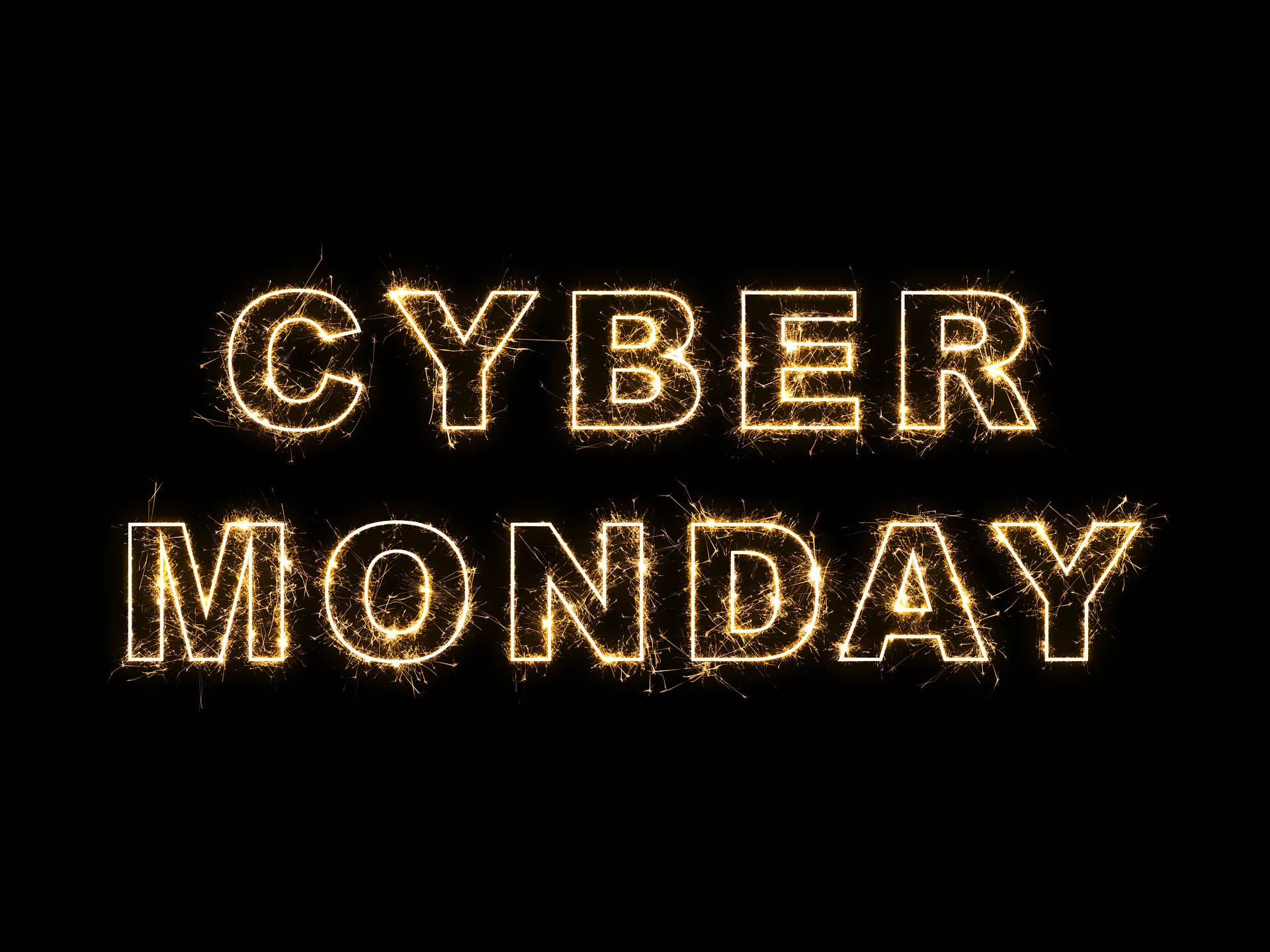 Shopping 桌布 壁紙 — 在純黑背景上，由發光金色煙火棒組成的粗體「CYBER MONDAY」文字。