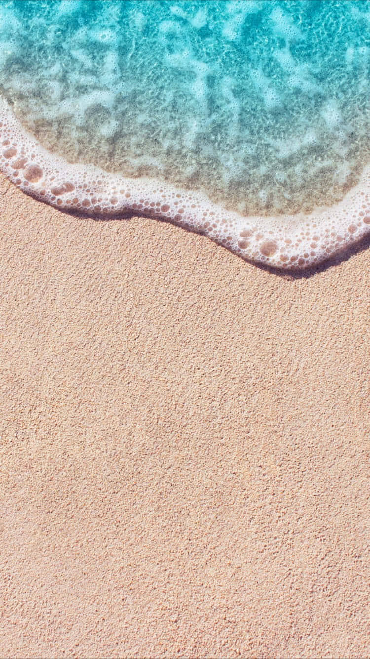 在美麗海灘享受夏日陽光！ 壁紙 — 特寫鏡頭：綠松石色的海浪輕輕拍打在柔軟的粉紅色沙灘上，形成細膩的白色泡沫。