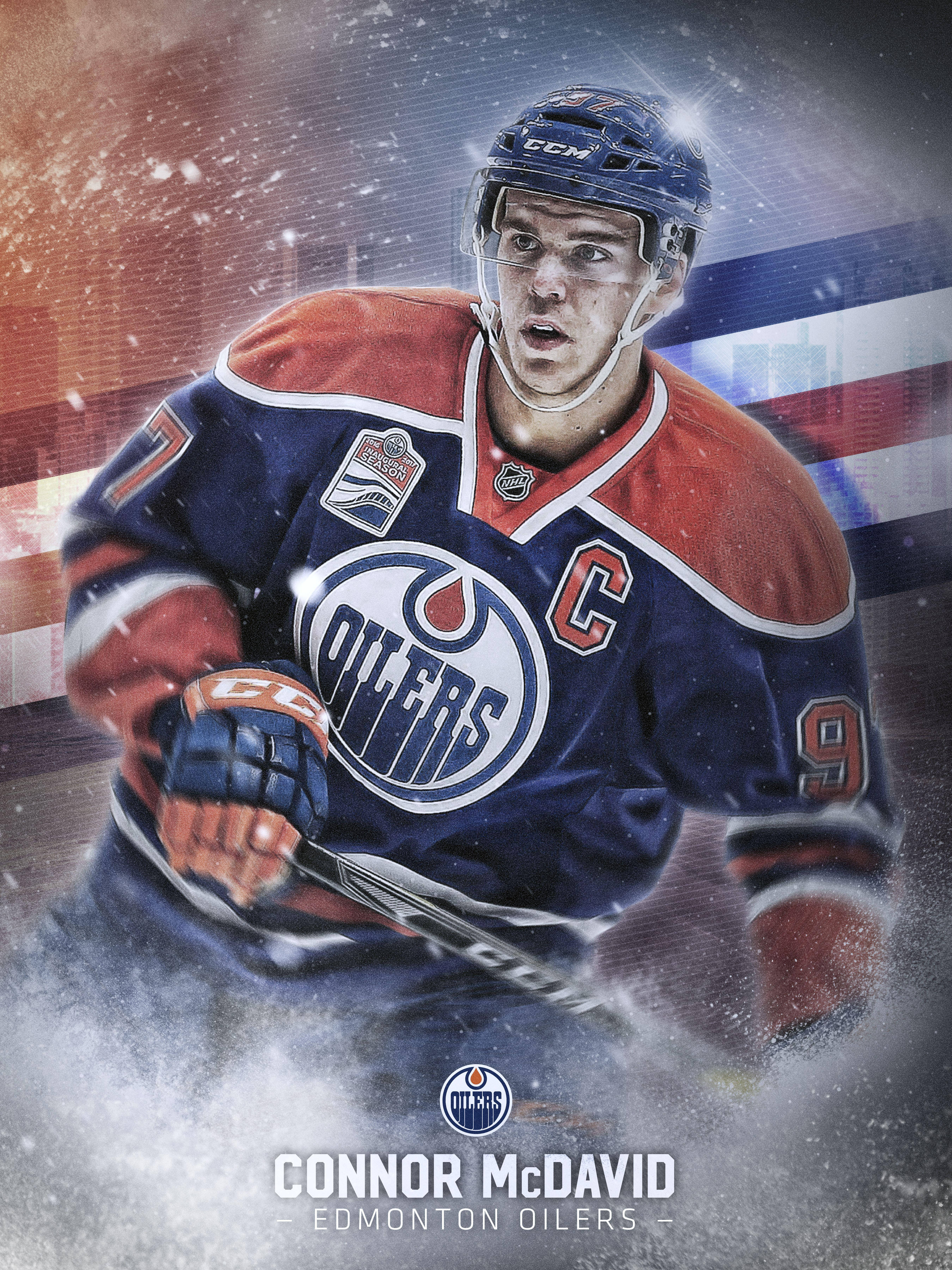 埃德蒙頓油人隊隊長康納·麥克戴維 壁紙 — 冰球球員 Connor McDavid 身穿 Edmonton Oilers 裝備，在雪景城市背景下充滿力量地向前衝刺。