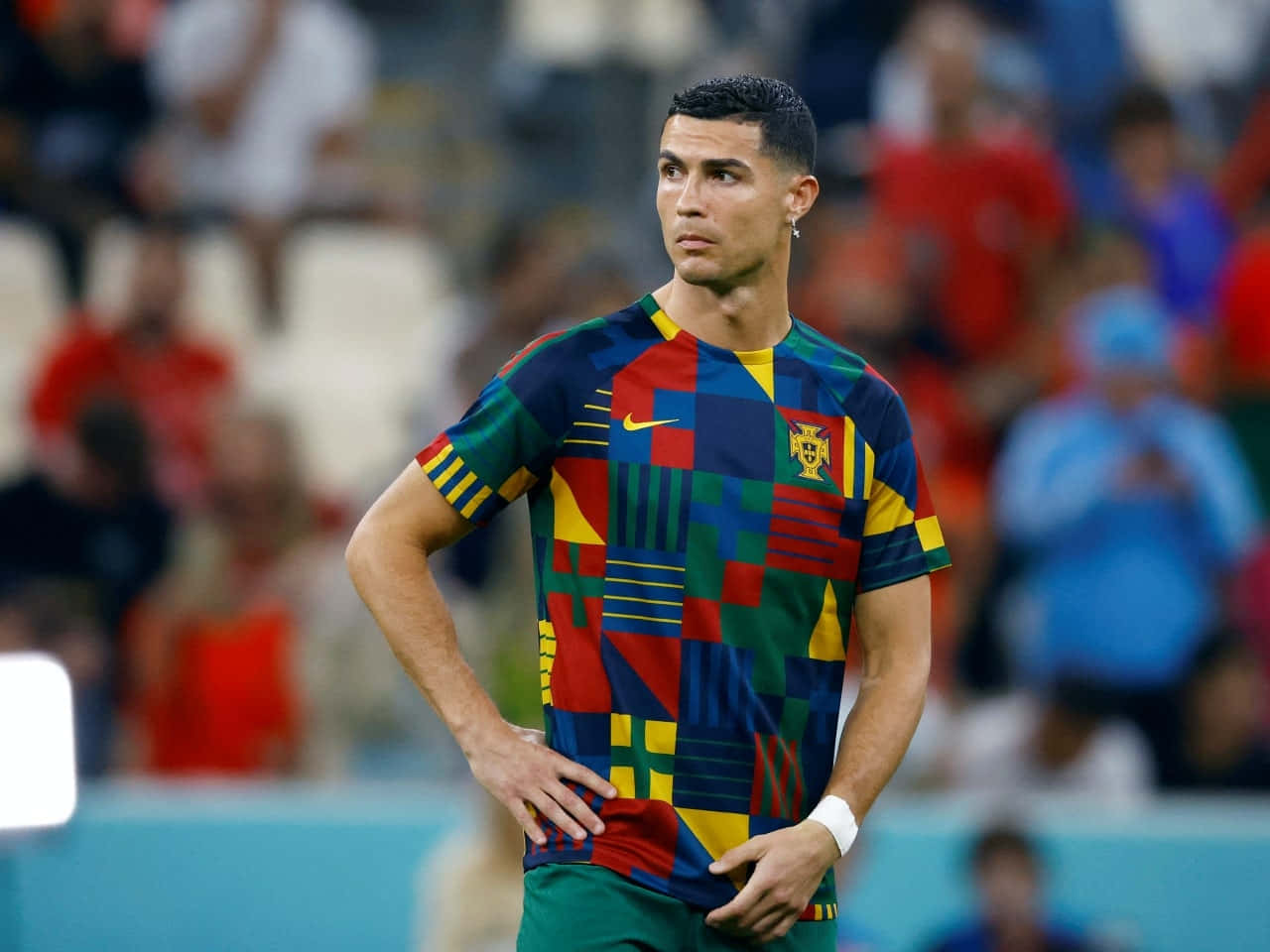 Cristiano Ronaldo 桌布 壁紙 — 基斯坦奴·朗拿度站在球場上，身穿色彩繽紛的幾何圖案葡萄牙球衣，雙手叉腰。