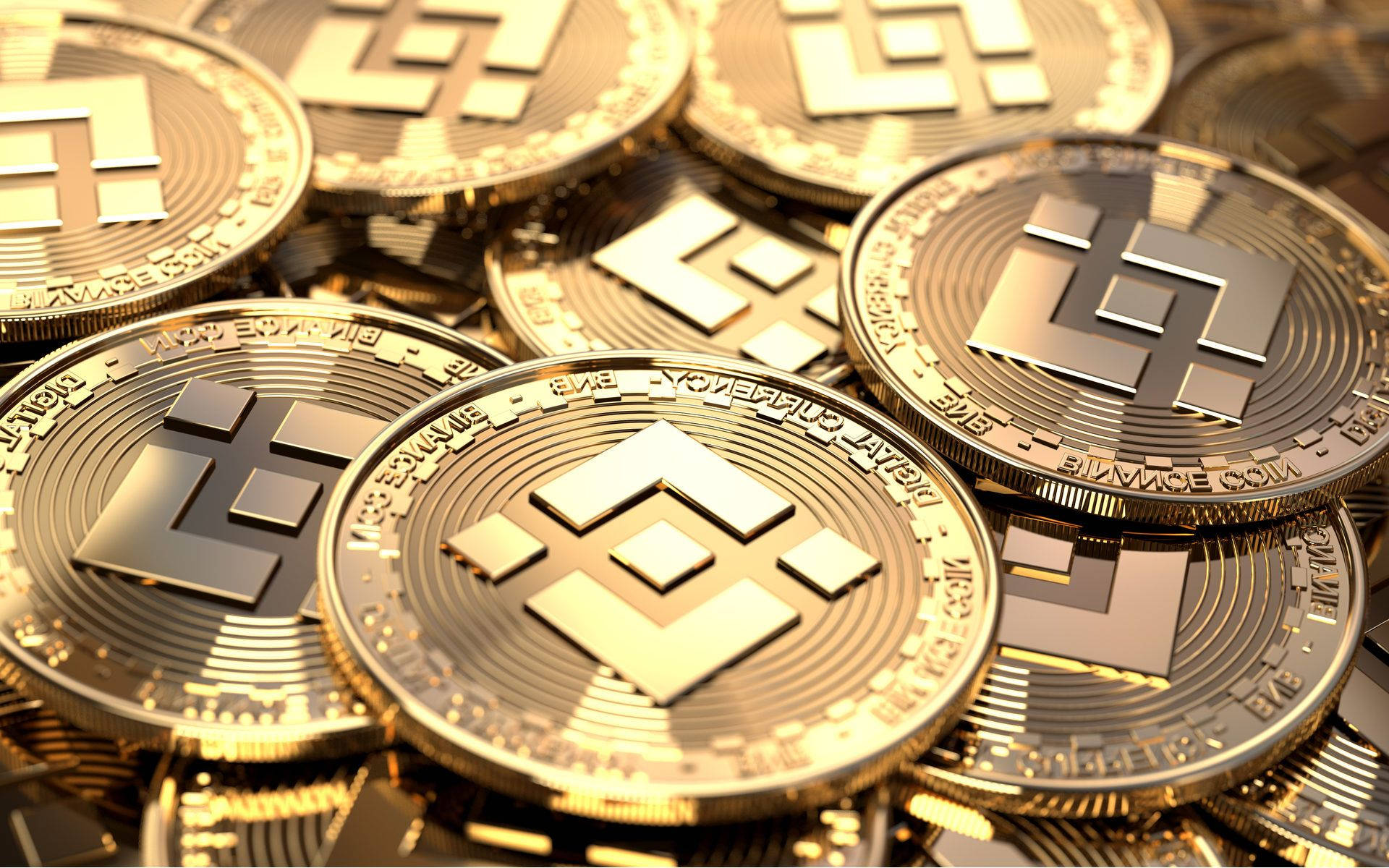 堆疊金色 Binance 代幣 壁紙 — 閃亮的金色Litecoin硬幣堆疊在一起，帶有精細雕刻和金屬反射。