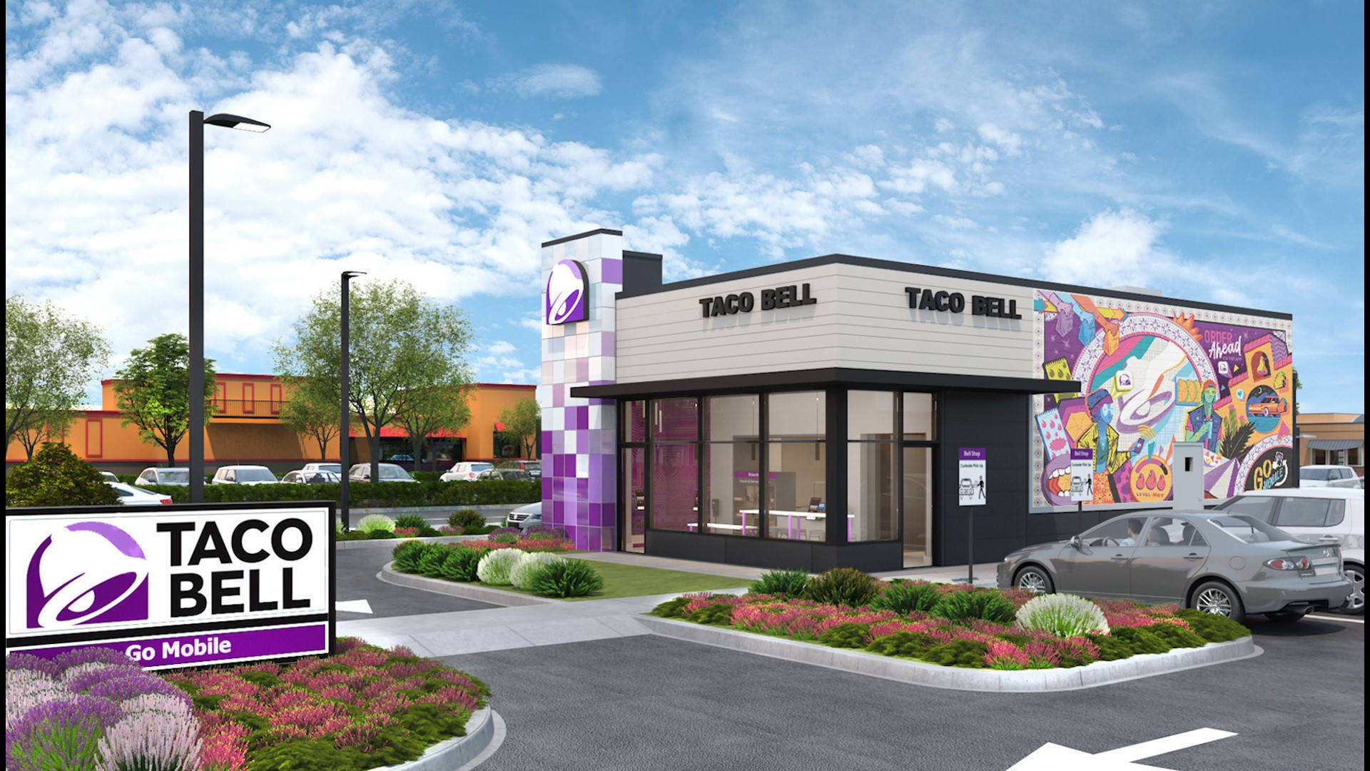 塔可鐘全新外觀圖案設計 壁紙 — 一間現代化的Taco Bell餐廳，帶有鮮豔的紫色點綴和色彩繽紛的壁畫藝術，在明亮的藍天和散落的雲朵下。