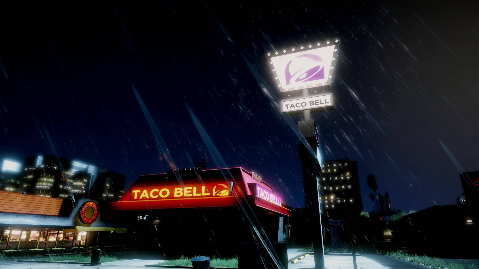 塔可鐘數位插畫 壁紙 — 一間Taco Bell餐廳在夜晚大雨中發光，雨絲劃過黑暗的天空。