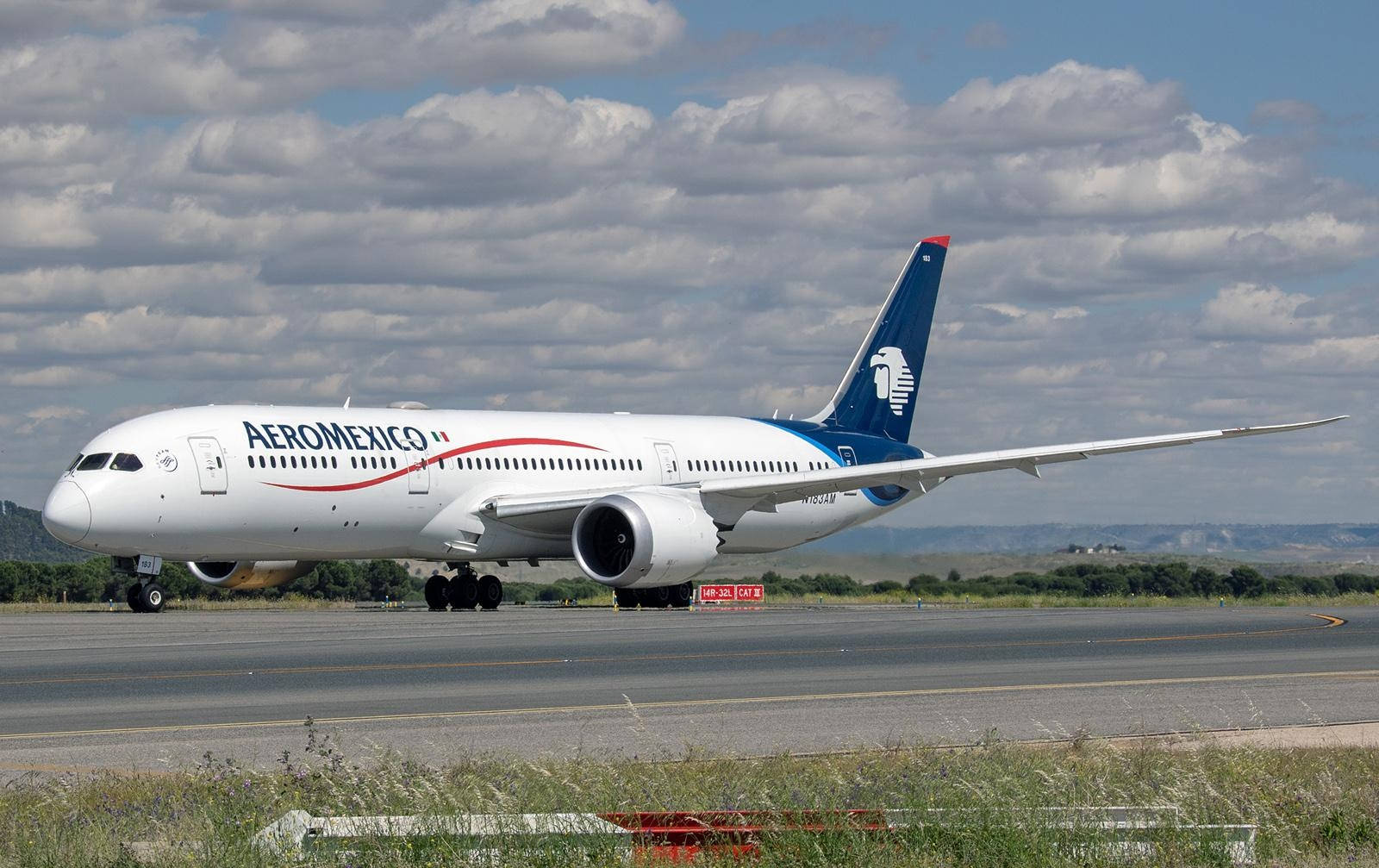 多雲天空下跑道上的 Aeromexico 飛機
