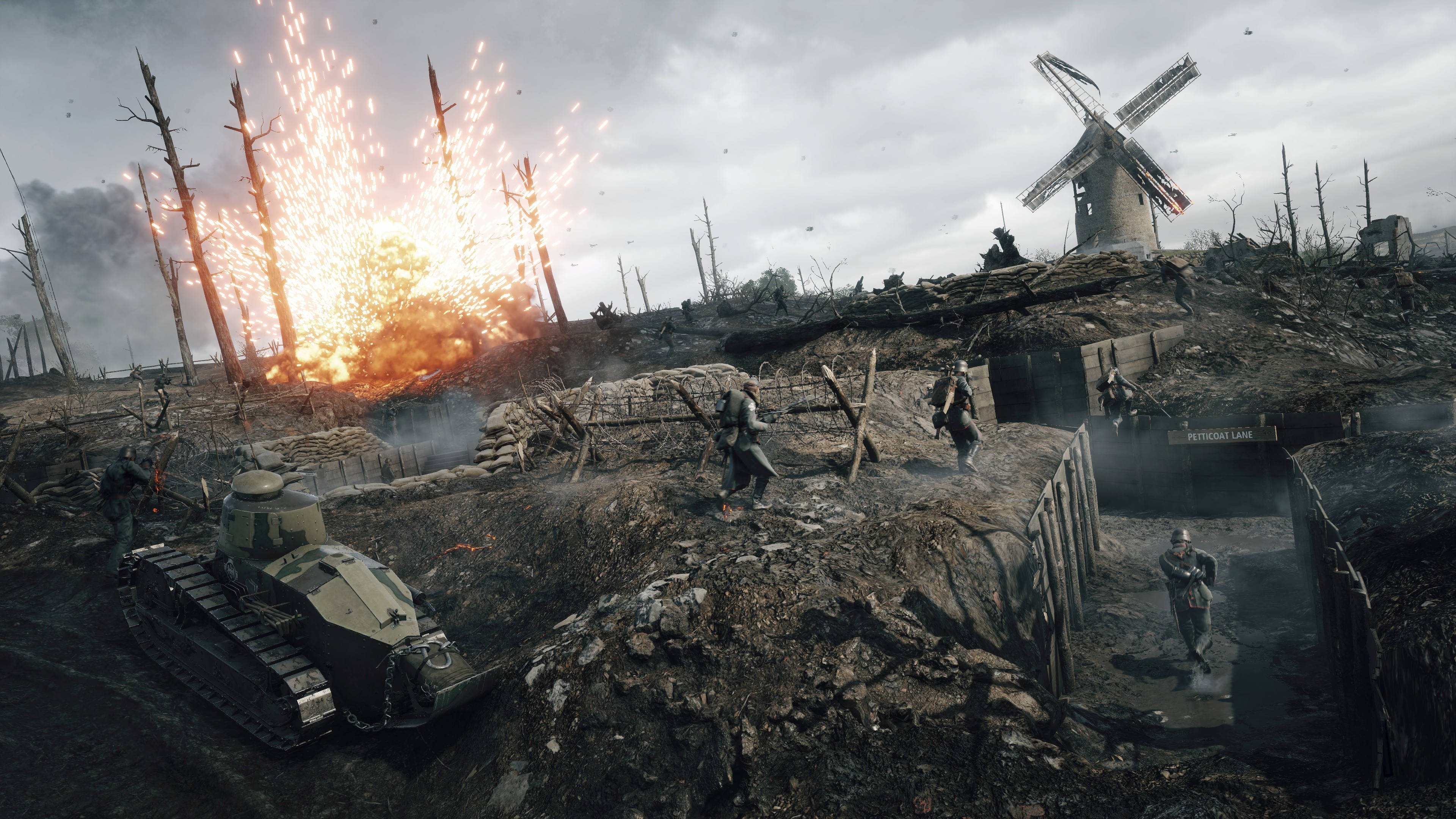 Battlefield 1 HD 桌布 壁紙 — 士兵們在戰爭蹂躪的戰場上前進，坦克向前移動，爆炸照亮了煙霧瀰漫的天空，附近有一座破損的風車。