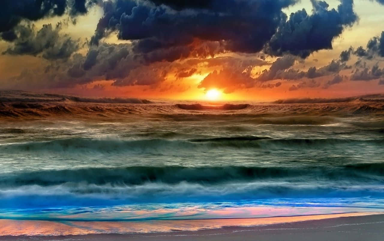 Colorful Sunset 桌布 壁紙 — 壯麗的日落，映照在翻騰的海浪上，火紅的橙雲和深藍的海水反射著太陽的光芒。
