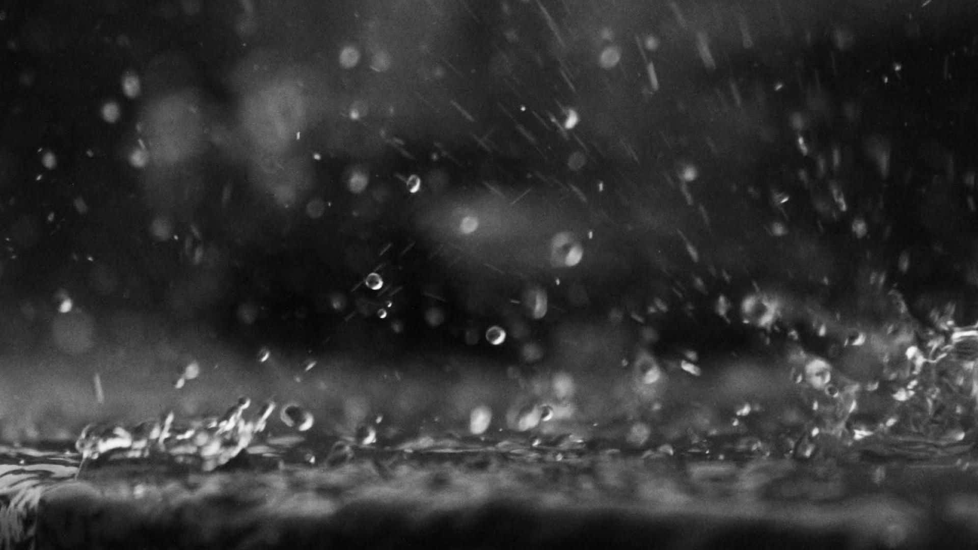 黑白雨滴在潮濕表面上飛濺。