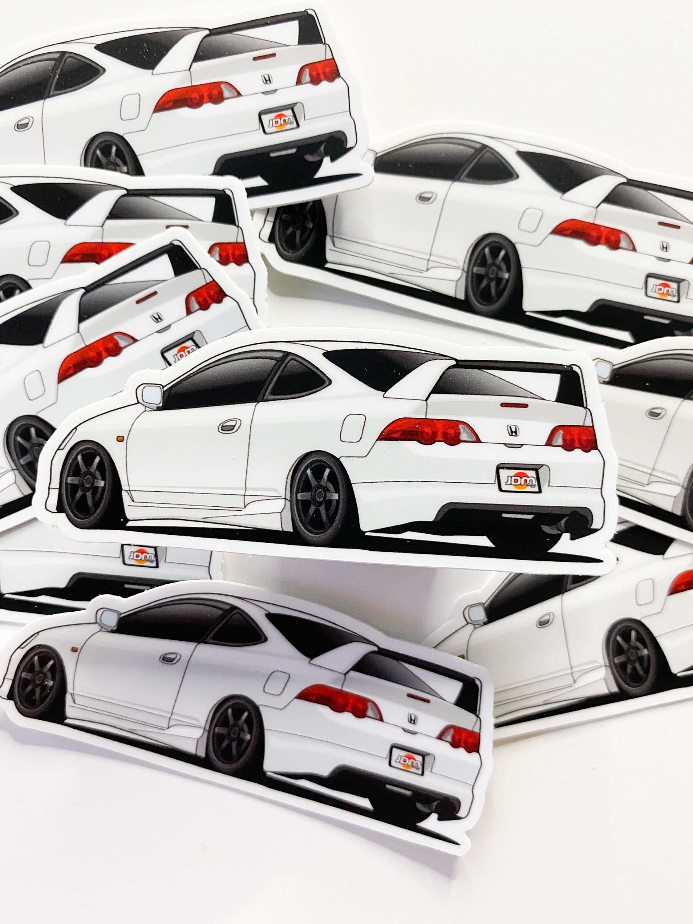 Acura Rsx 桌布 壁紙 — 多個帶有紅色尾燈的白色本田轎跑車貼紙散落在純白色表面上。