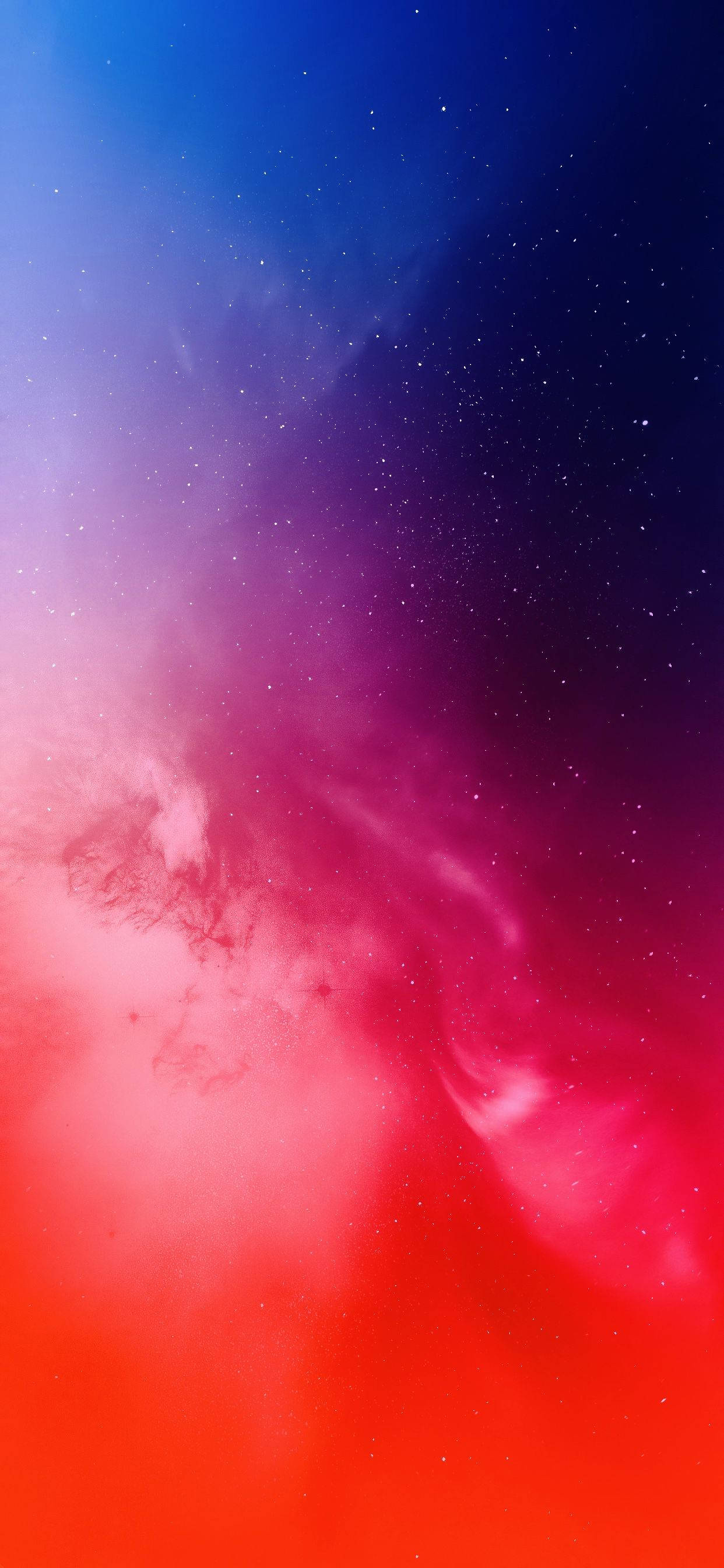 多彩太空 iPhone 11 Pro Max 壁紙 — 充滿活力的宇宙星雲從火紅色旋轉到深藍色，發光的星星散落在天際。