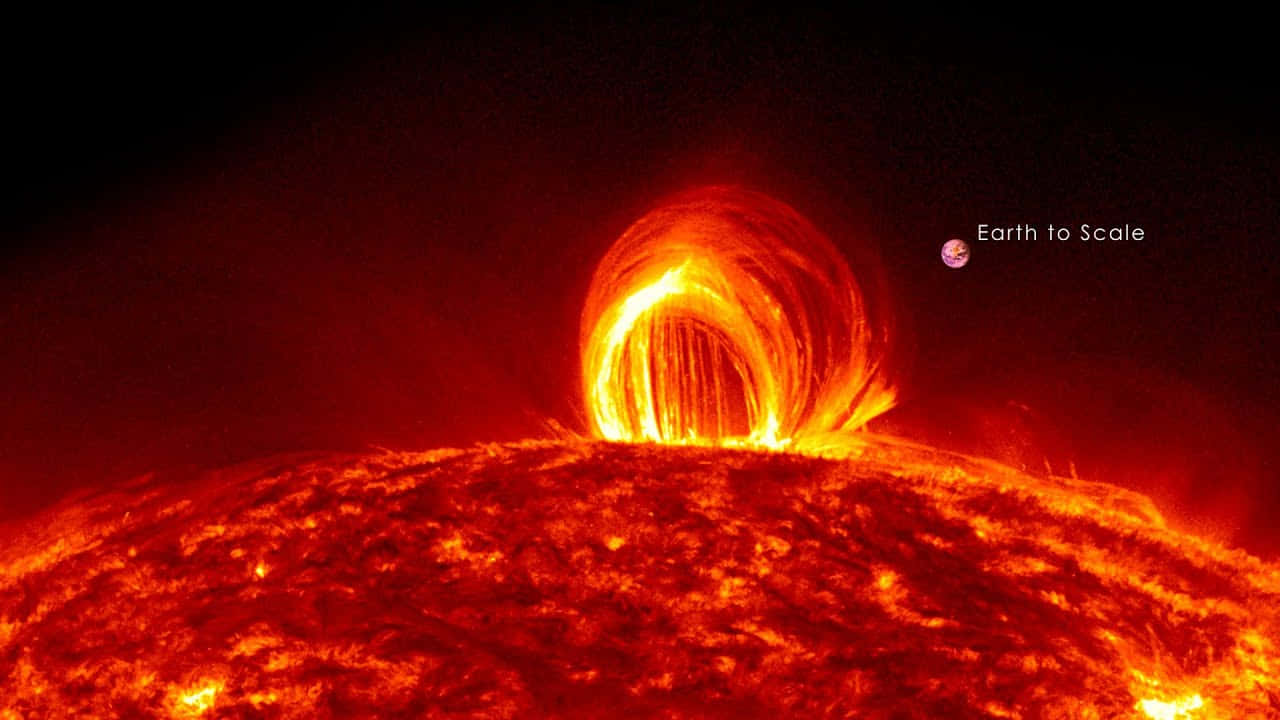 從太陽噴發的太陽日珥，地球在太空中作為比例尺。