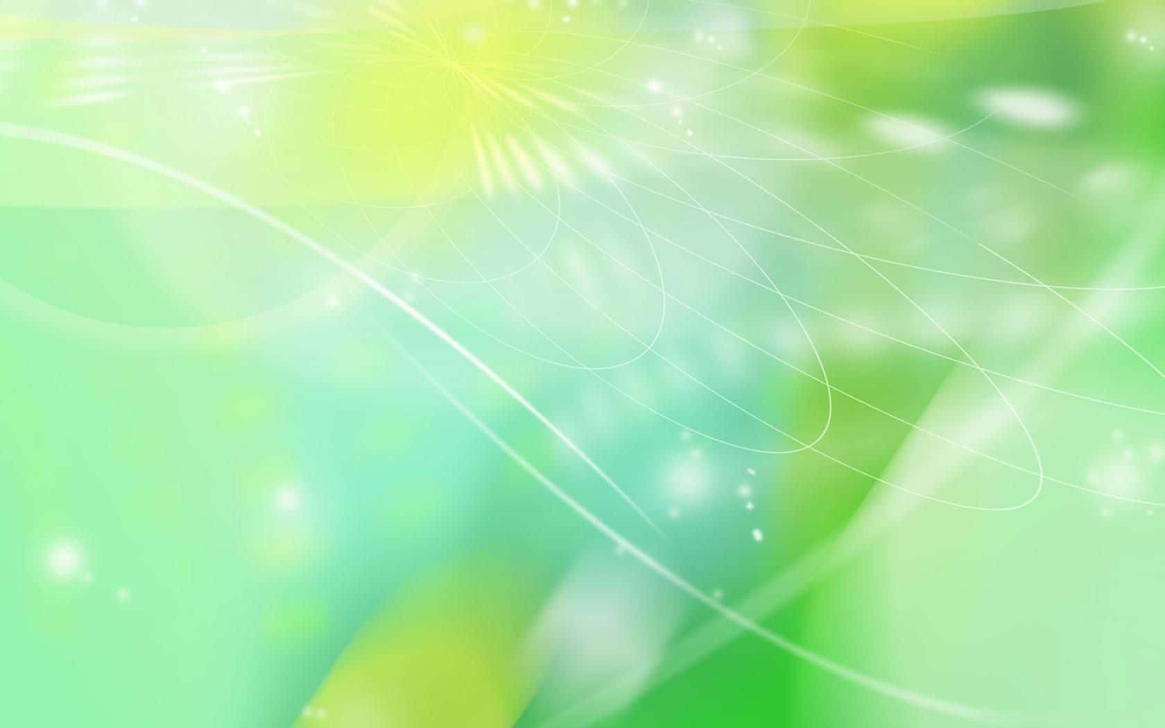 多彩綠色抽象藝術 壁紙 — 柔和的綠色和黃色漸變與發光的燈光條紋和閃爍的粒子在夢幻般的抽象構圖中旋轉。