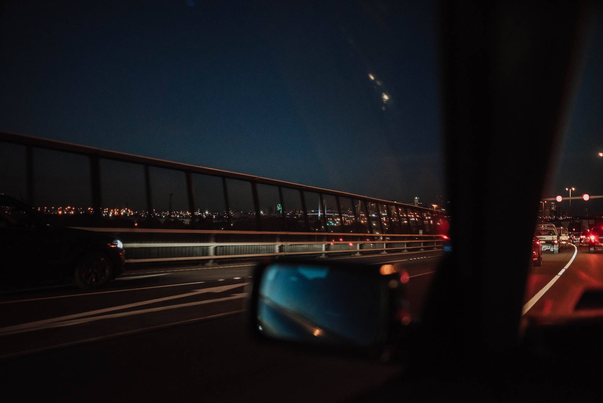 夜間高速公路駕駛，透過車窗可見城市燈光