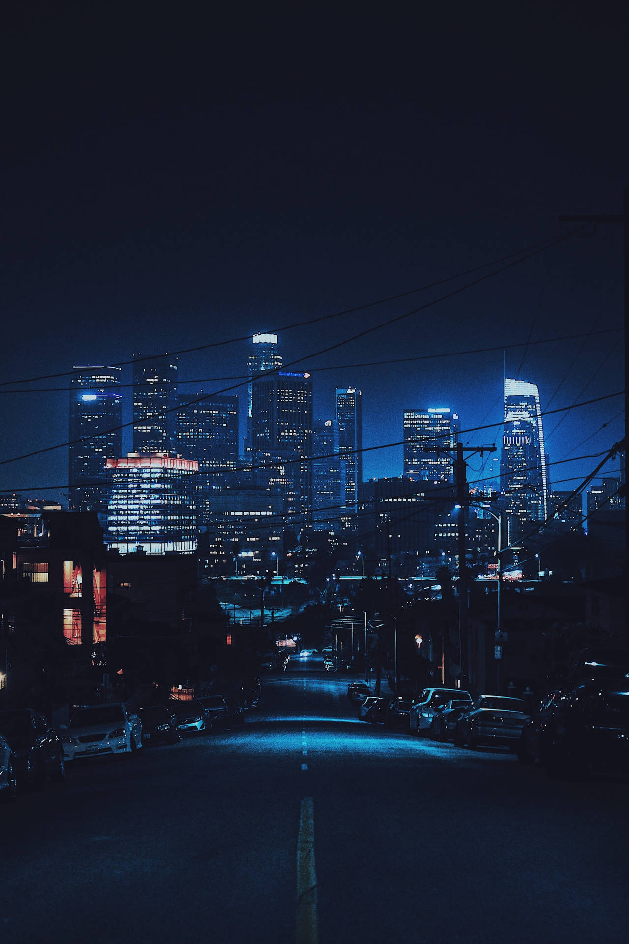 從黑暗街道觀看閃爍摩天大樓的夜景。