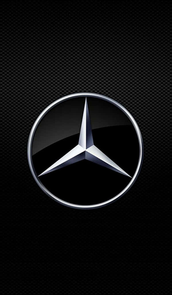 夢幻熱帶海灘 壁紙 — 閃亮的銀色Mercedes-Benz標誌置於有紋理的黑色碳纖維背景中央。