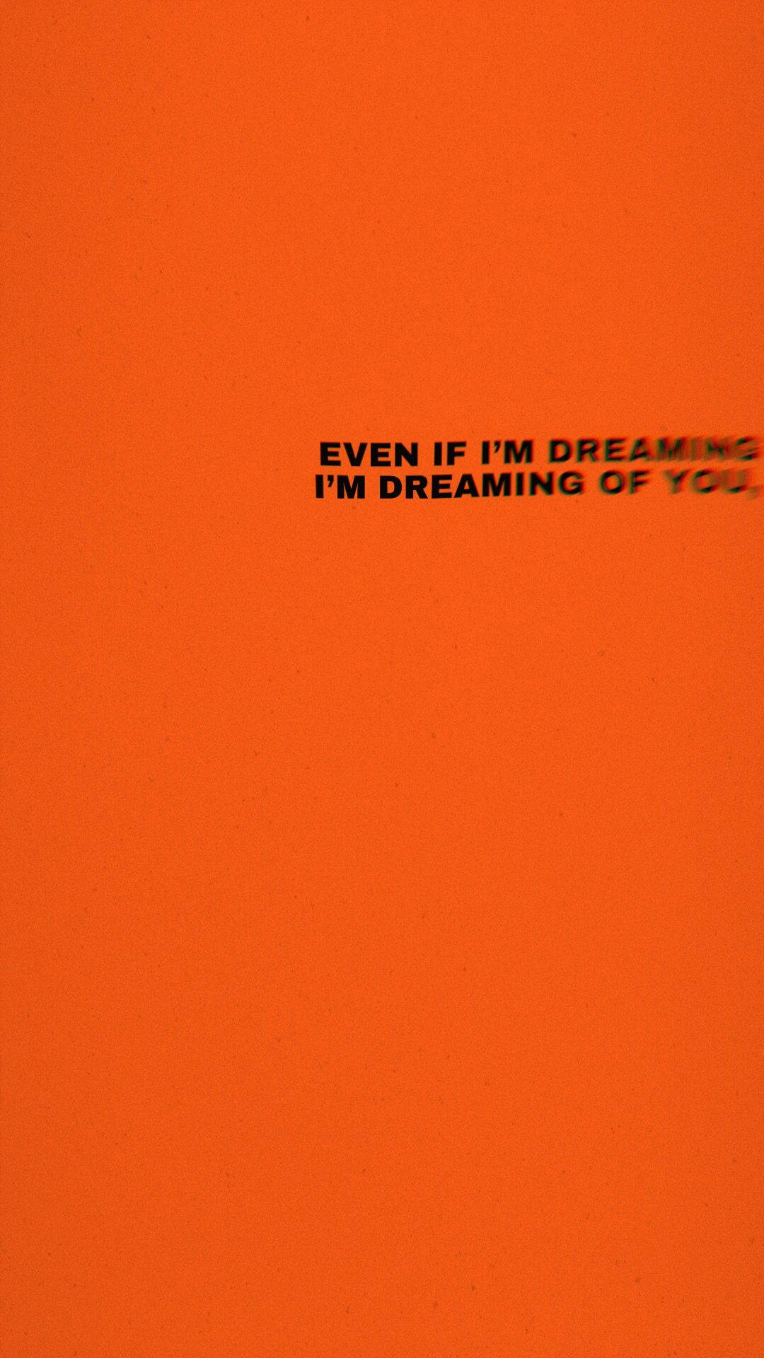 夢見你愛語 壁紙 — 粗體黑色文字寫著 even if i'm dreaming i'm dreaming of you，背景為紋理鮮豔的橙色。