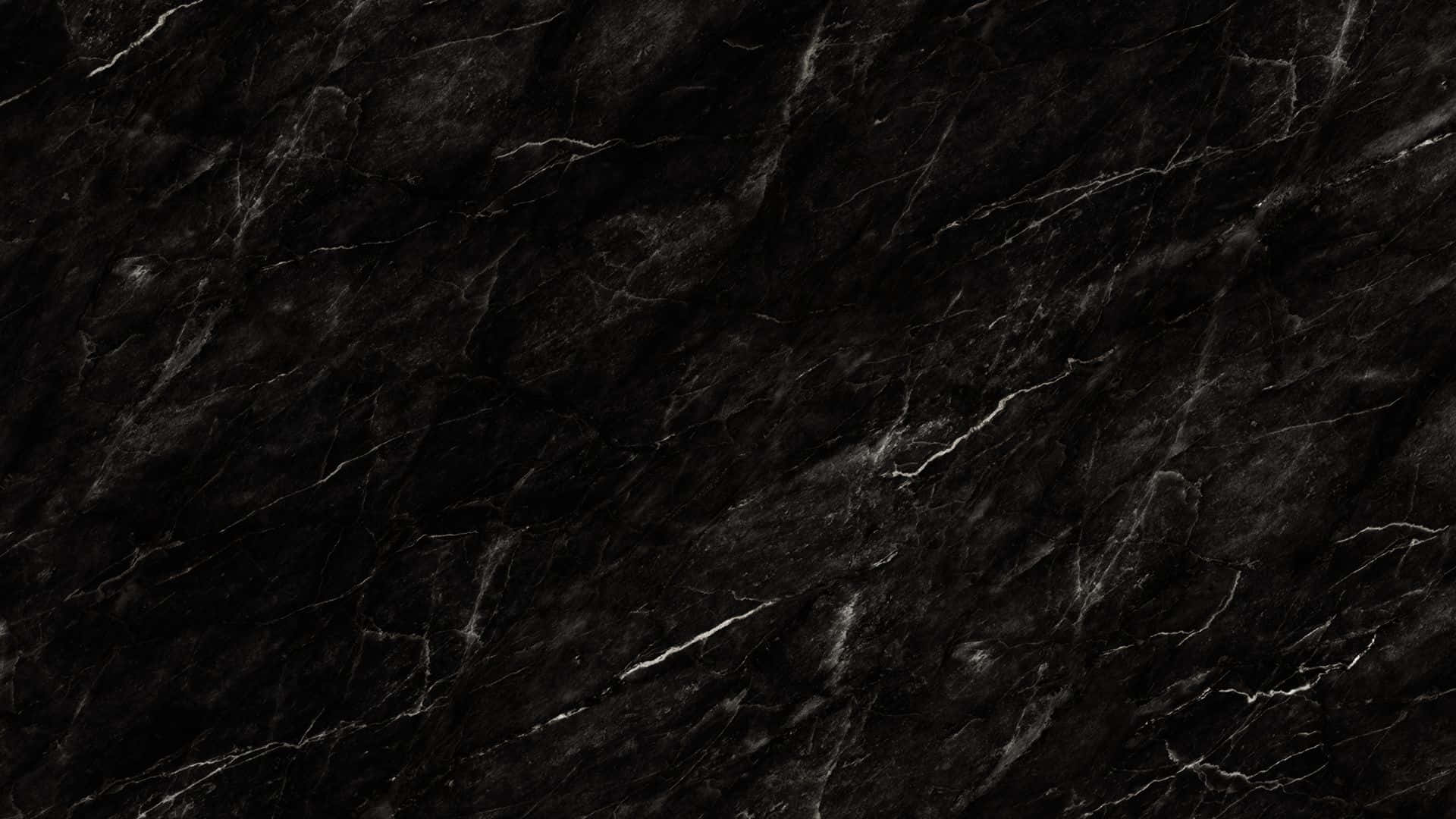 大理石紋理黑色背景 壁紙 — 光面黑色大理石的近距離特寫，帶有複雜的白色紋理，營造出奢華精緻的質感。