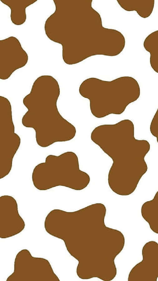 Brown Cow Print 桌布 壁紙 — 大膽的乳牛印花圖案，在潔白背景上帶有不規則的棕色斑塊。