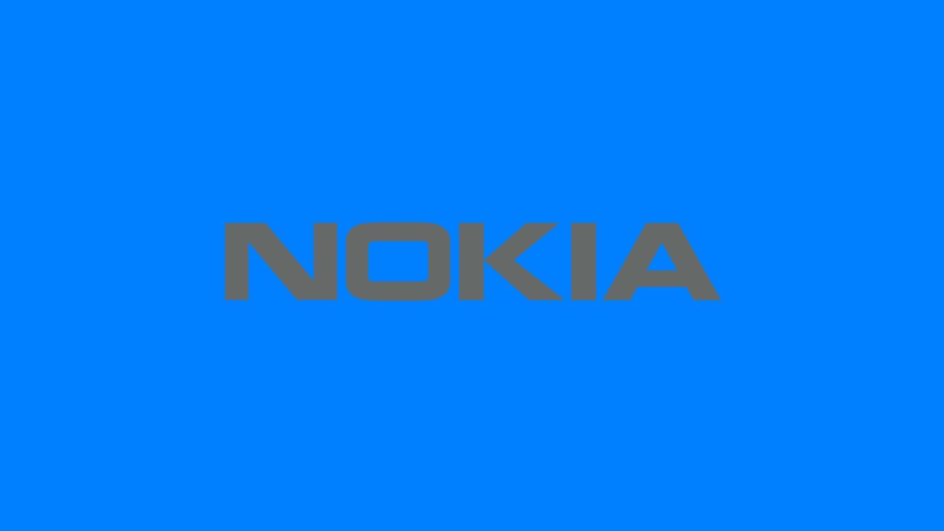 Nokia 桌布 壁紙 — 大膽的灰色 Nokia 標誌居中放置在純色鮮豔藍色背景上。