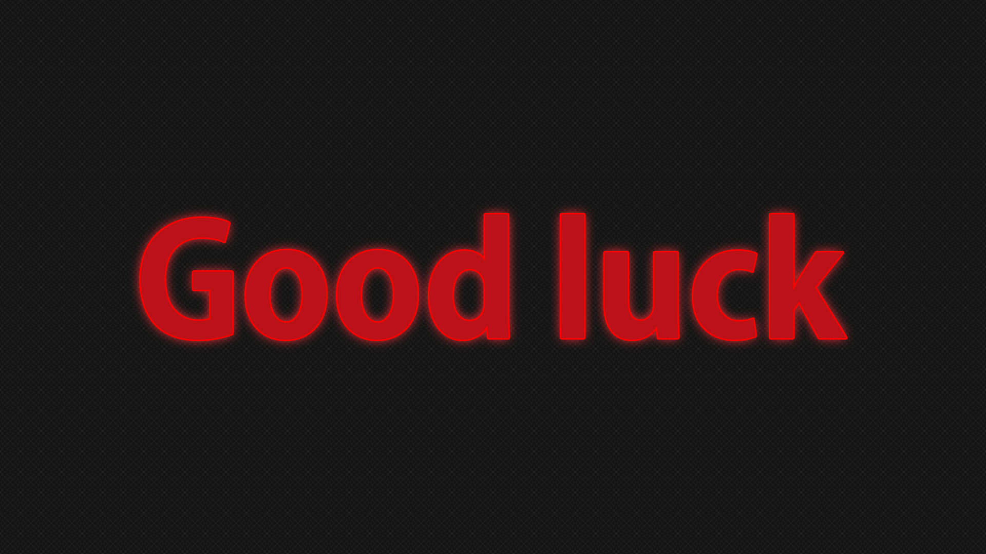 好運 桌布 壁紙 — 大膽的紅色「Good luck」文字在帶有微妙網格圖案的深色紋理背景上發光。