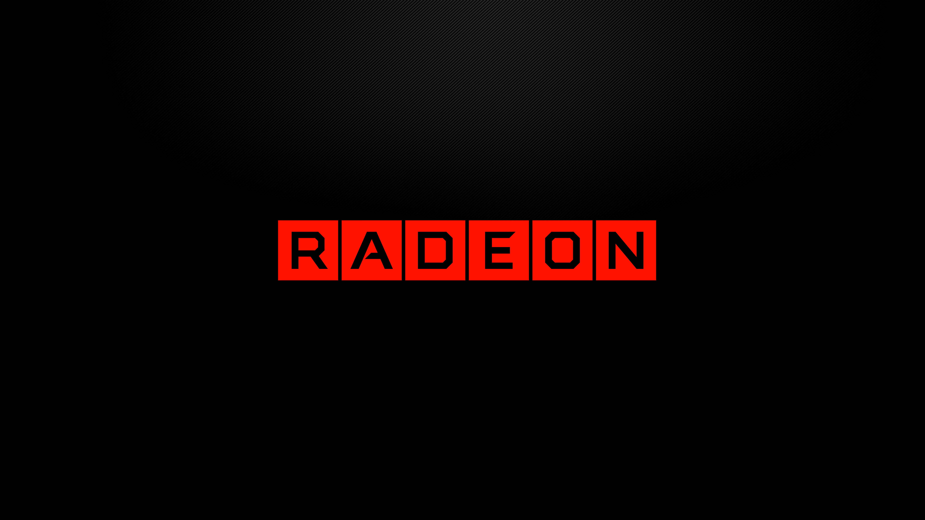 4K 桌布 壁紙 — 大膽的紅色 Radeon 標誌居中於帶有微妙漸變的深色紋理黑色背景上。