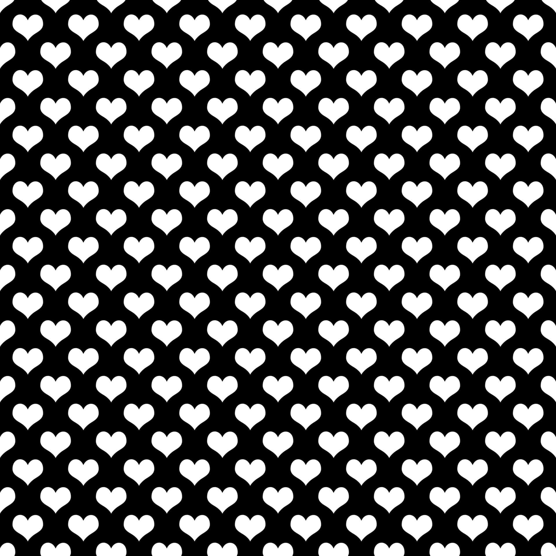 Black And White Heart 桌布 壁紙 — 大膽的黑白牆紙，黑色背景上重複排列白色心形圖案。