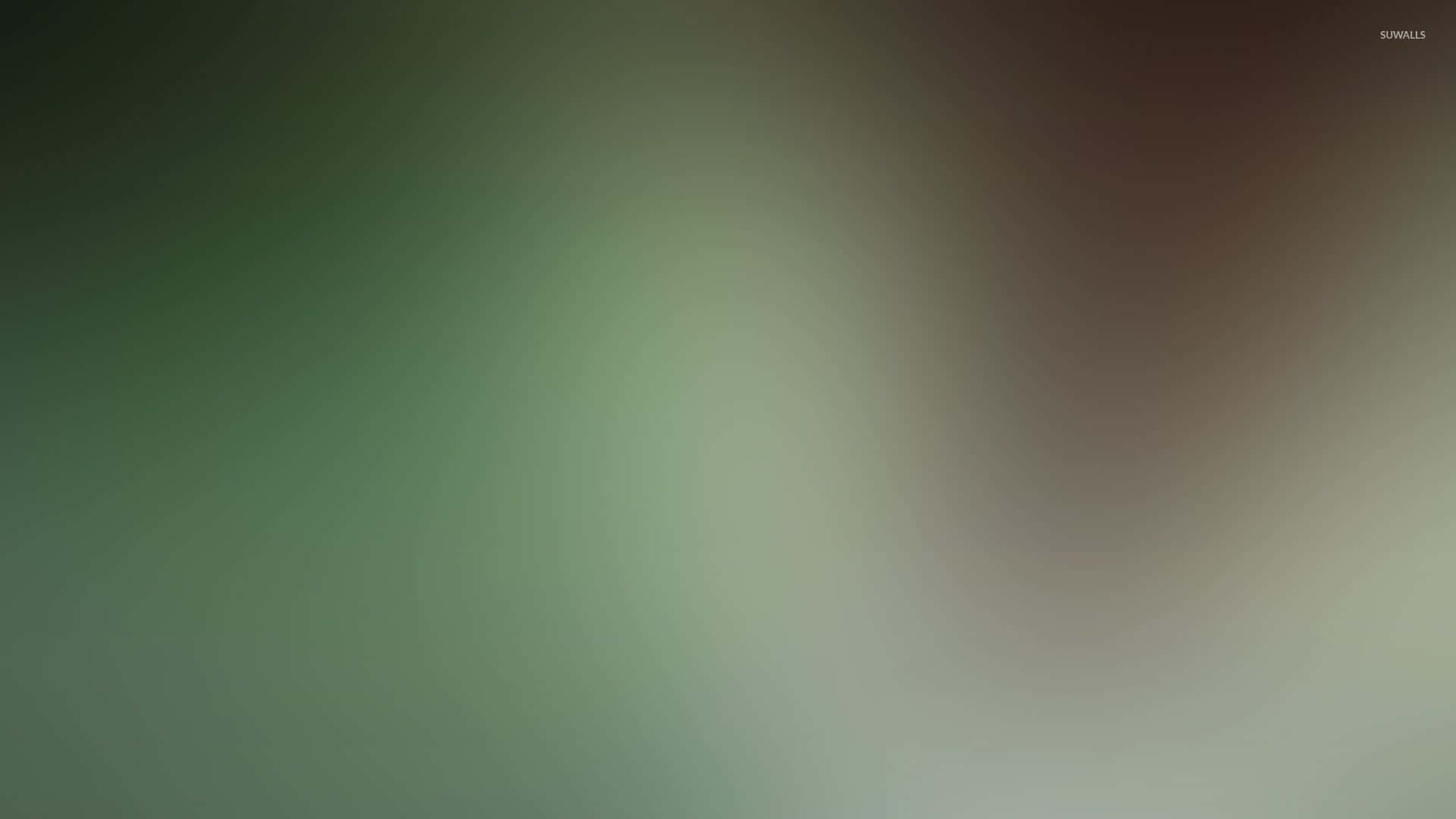 帶有柔和綠色和棕色色調的抽象漸變背景。