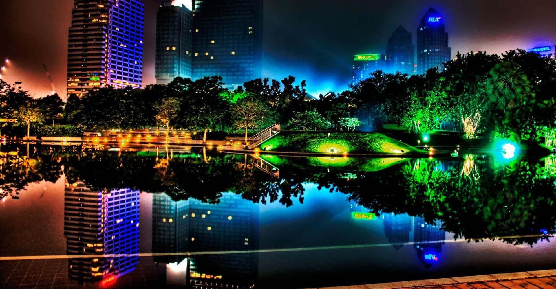 霓虹城市天際線在夜間倒映在寧靜的池塘中，伴隨著發光的綠色樹木。