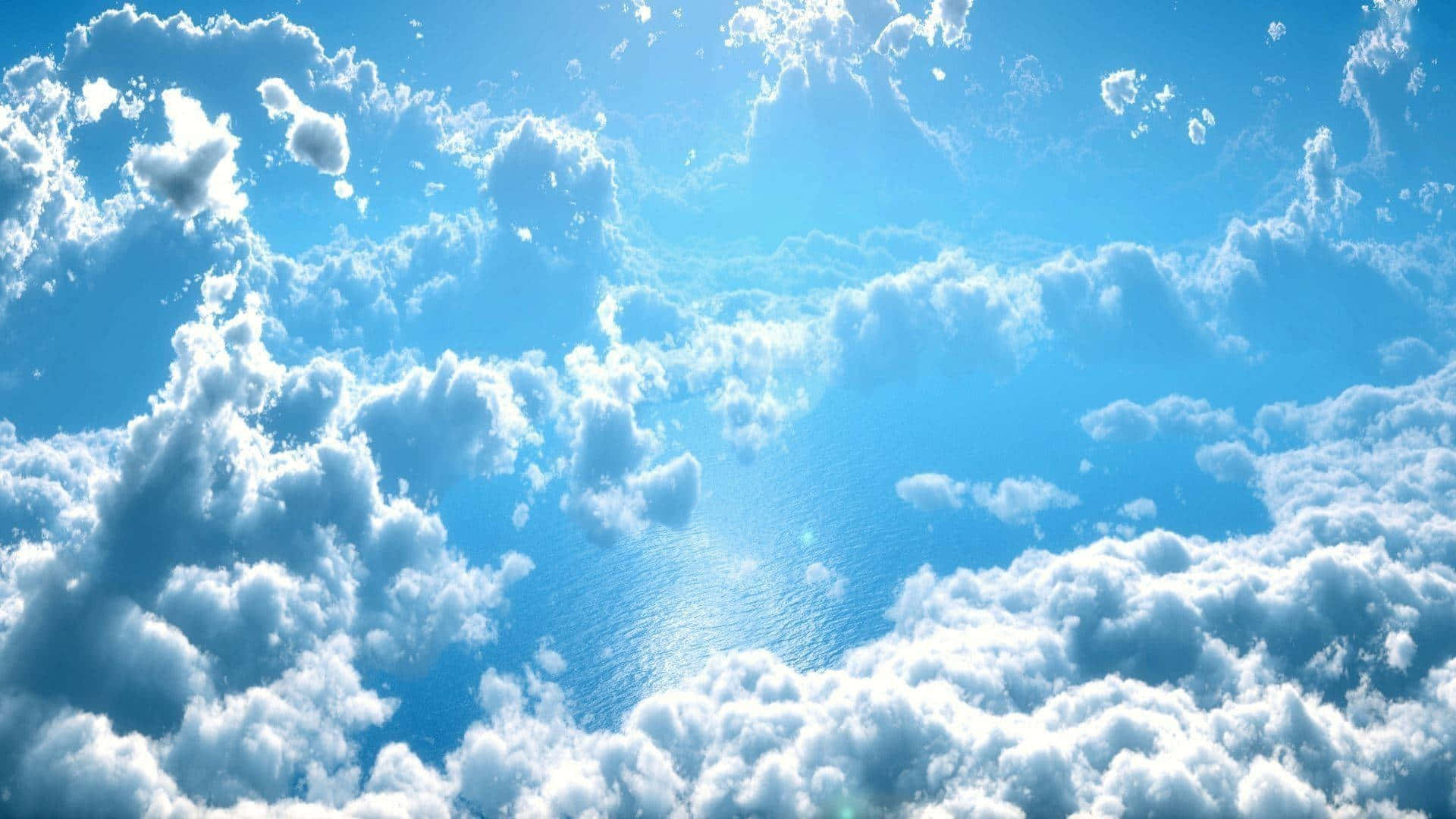 天堂雲朵的美麗 壁紙 — 廣闊的藍天充滿了蓬鬆的白雲，沐浴在明亮的陽光下，營造出寧靜而寬廣的氛圍。