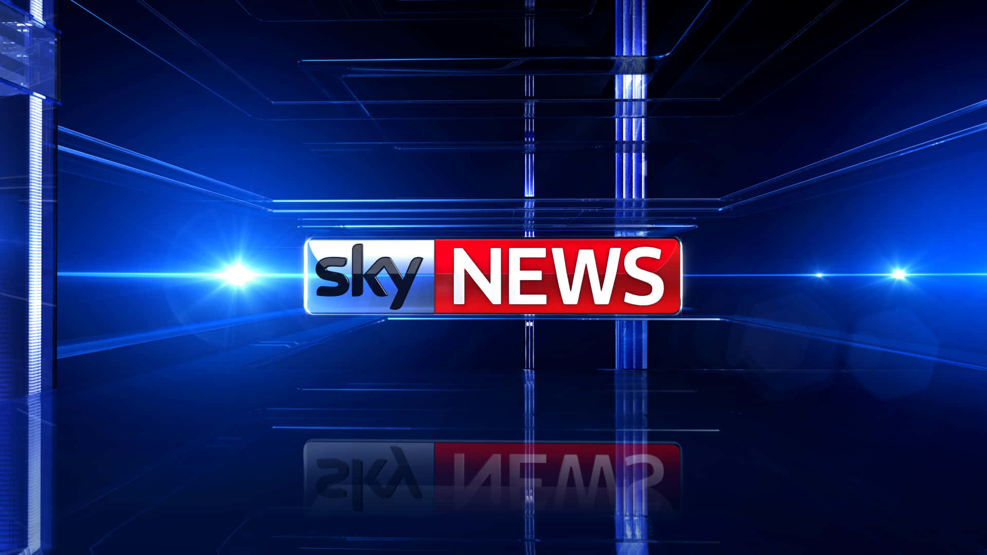 Sky News 標誌在高科技藍色廣播攝影棚中，帶有鏡頭光暈。