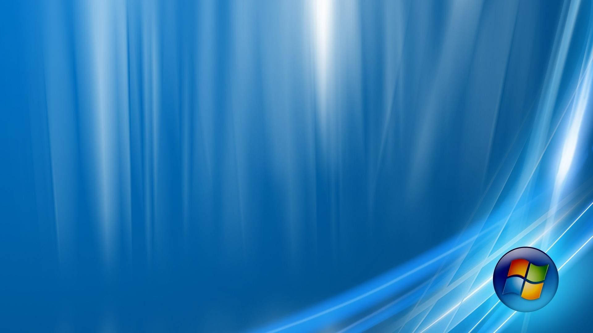天藍色 Windows Vista 壁紙 — 動態藍色抽象壁紙，帶有發光的光條和右下角的Windows標誌。