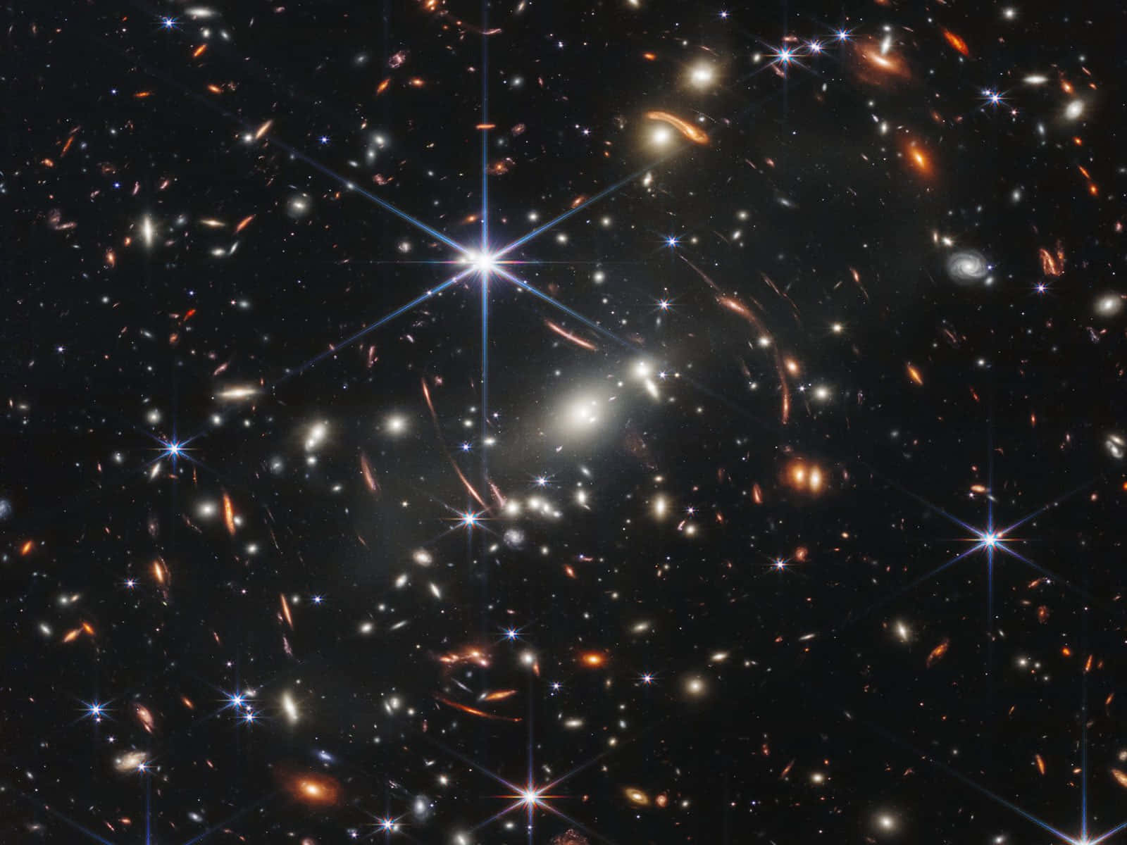 太空中的明亮星群天文 壁紙 — 一片宇宙景觀，充滿發光的星系和明亮的星星，背景是深邃的黑色虛空。
