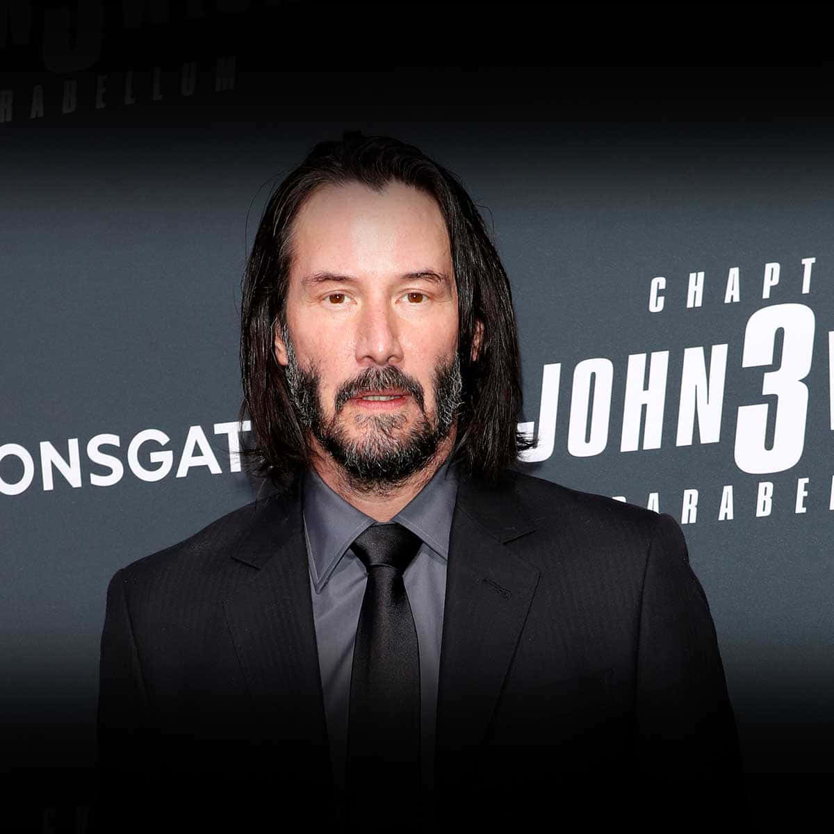 Keanu Reeves 桌布 壁紙 — 奇洛·李維斯身穿黑色西裝，站在帶有『John Wick Chapter 3』文字的深色背景前。