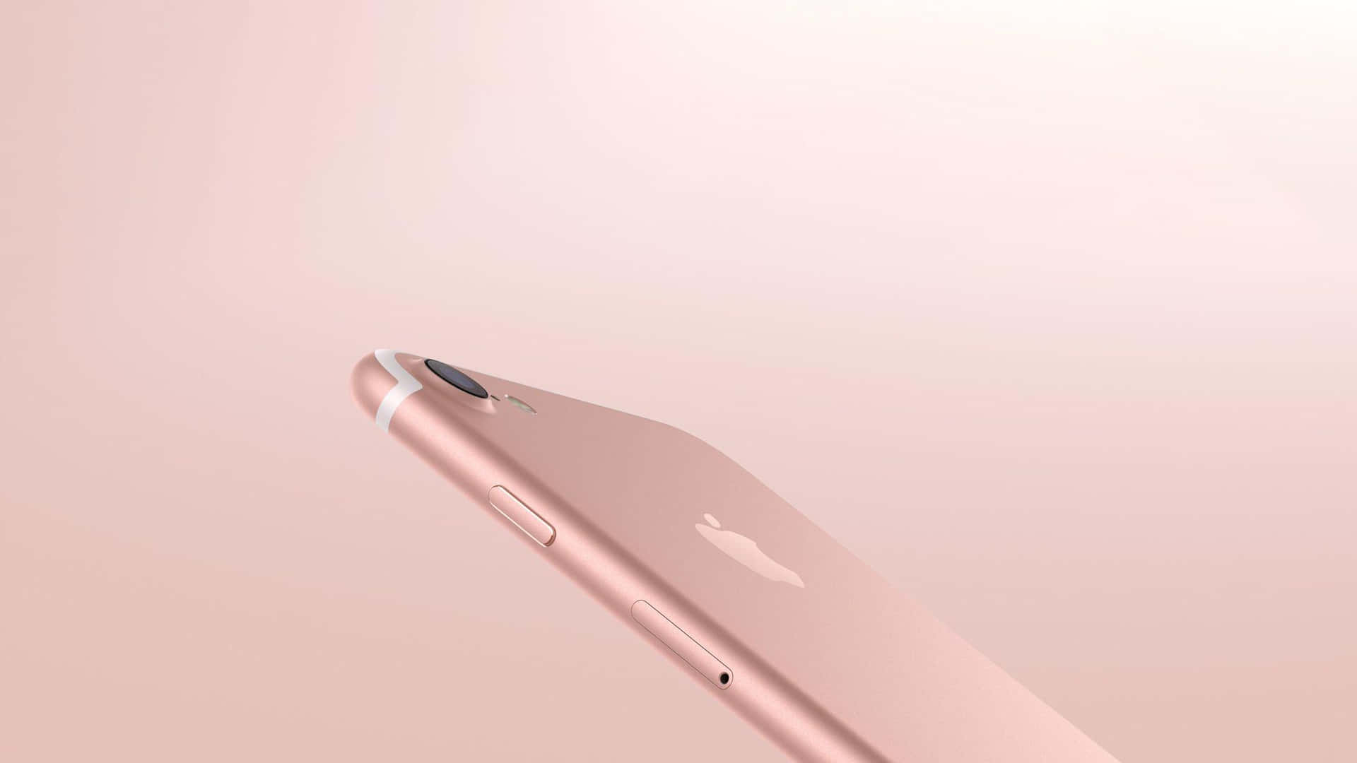 玫瑰金色iPhone在柔和粉紅色背景上帶有Apple標誌