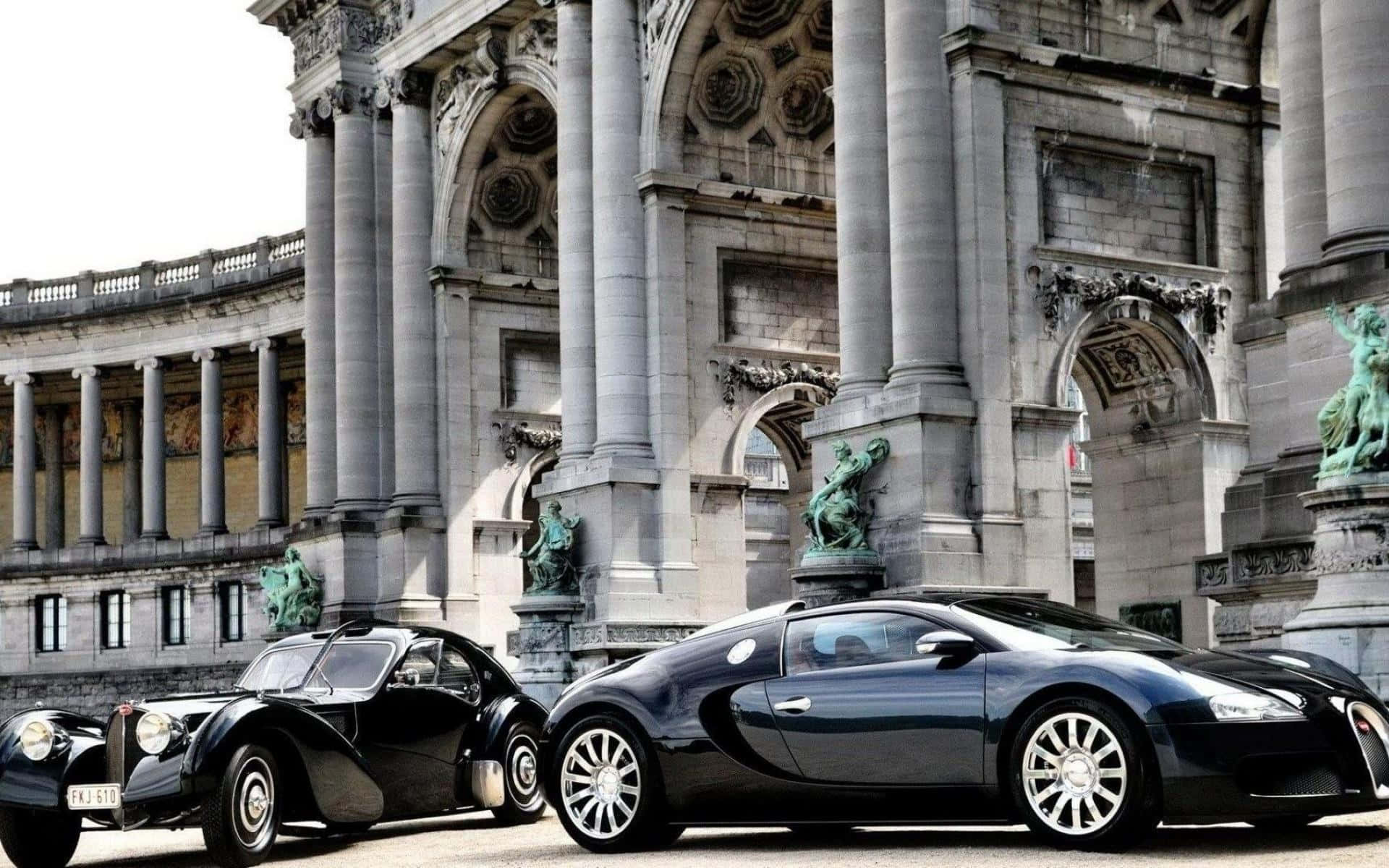 兩輛布加迪汽車停在一棟帶有雕像的宏偉石建築前。