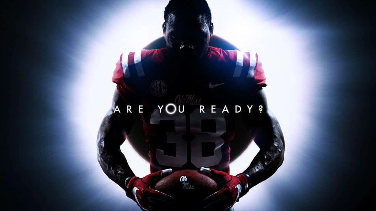 紅色球衣的足球運動員在明亮的聚光燈下拿著球，並帶有文字「ARE YOU READY？」