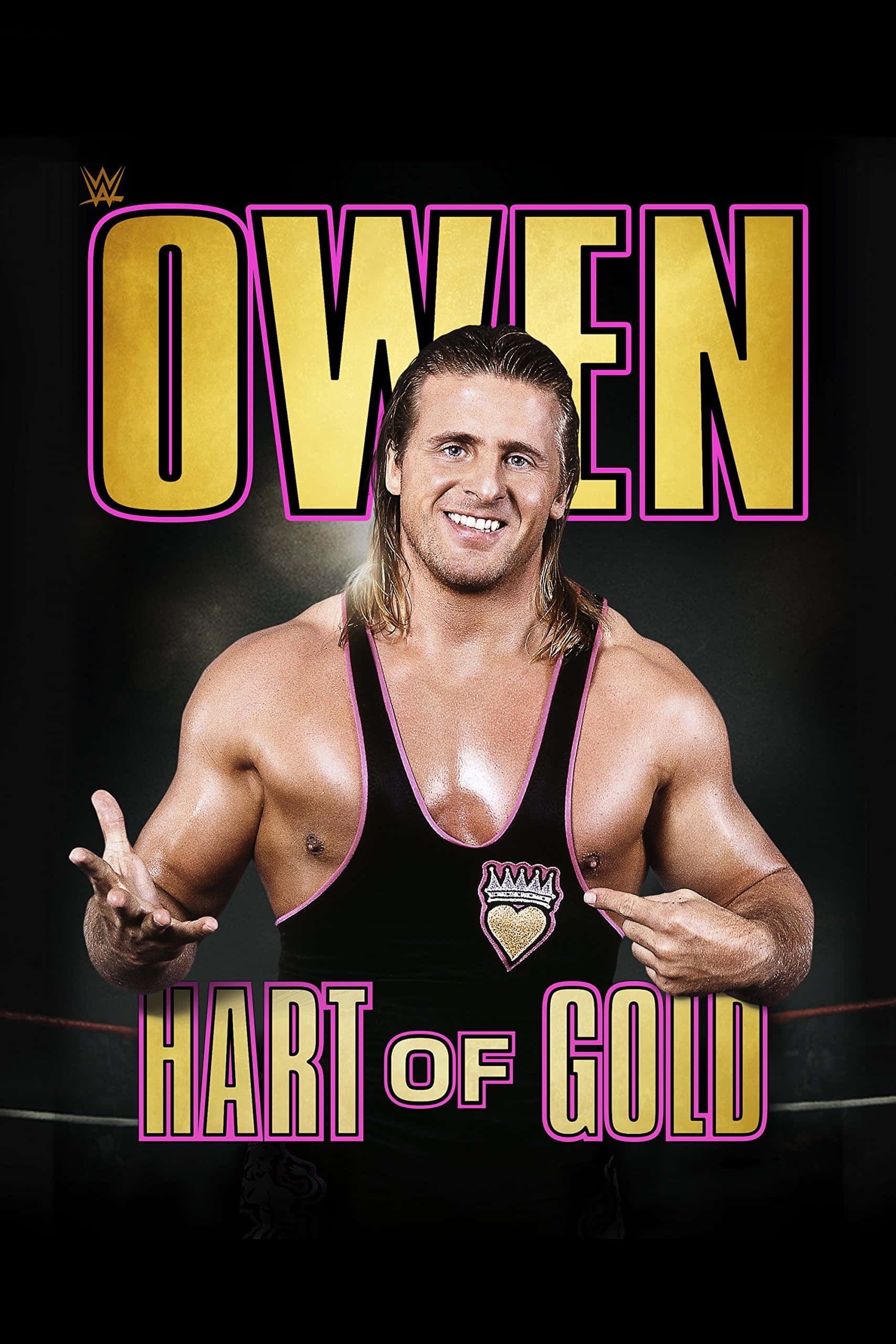 奧文·哈特——金心之王 壁紙 — WWE摔角手Owen Hart自信地微笑，身穿黑色摔角緊身衣，上面有金色和粉紅色的文字寫著「OWEN」和「HART OF GOLD」，背景為深色。