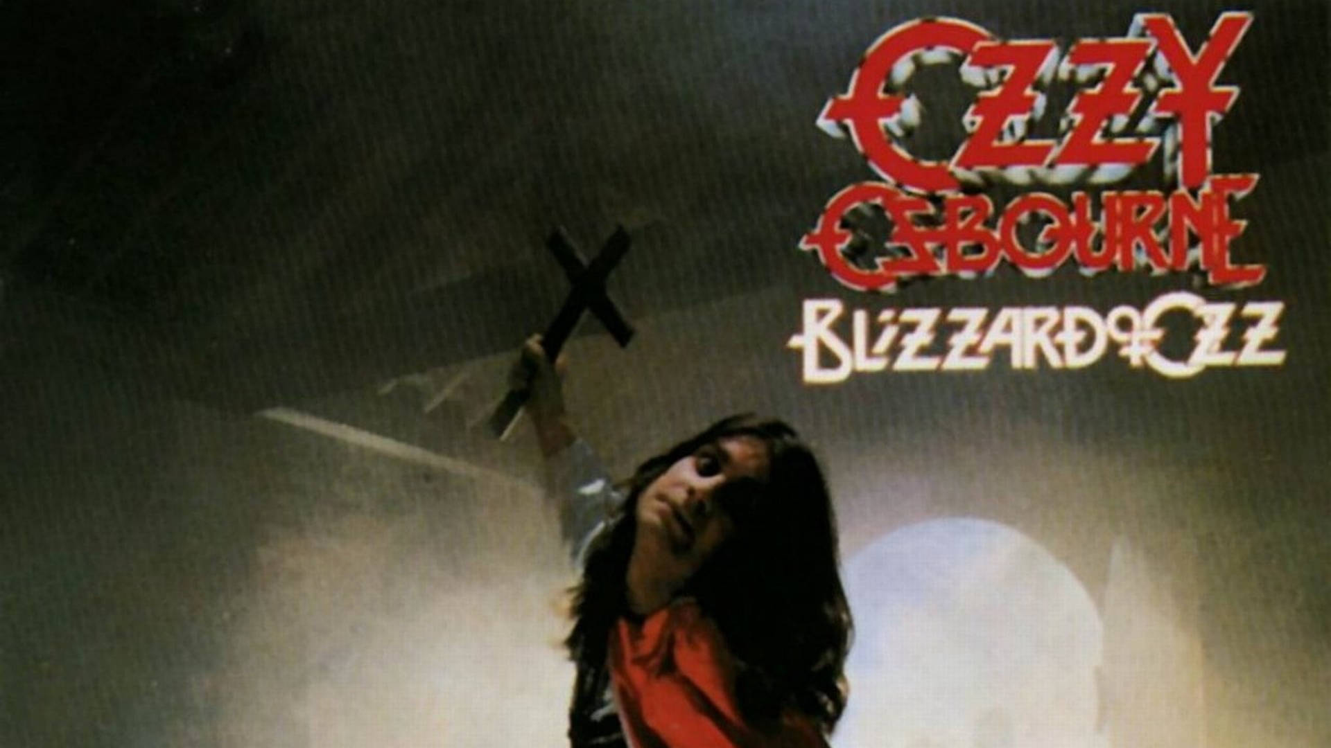 Ozzy Osbourne 在煙霧繚繞的舞台燈光中手持黑色十字架，身後是專輯標題。
