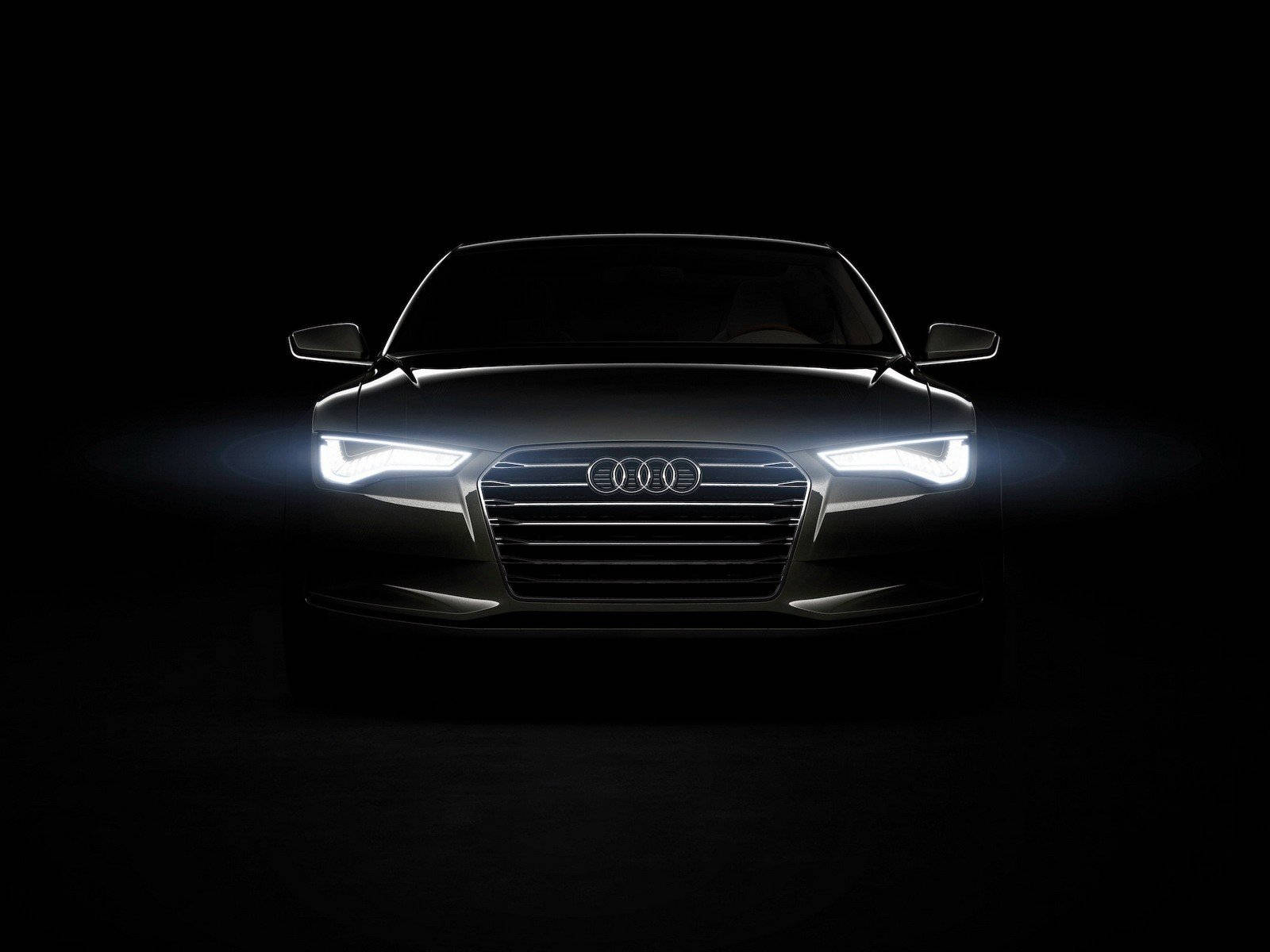 Audi 汽車正面，在黑暗的攝影棚中車頭燈閃耀