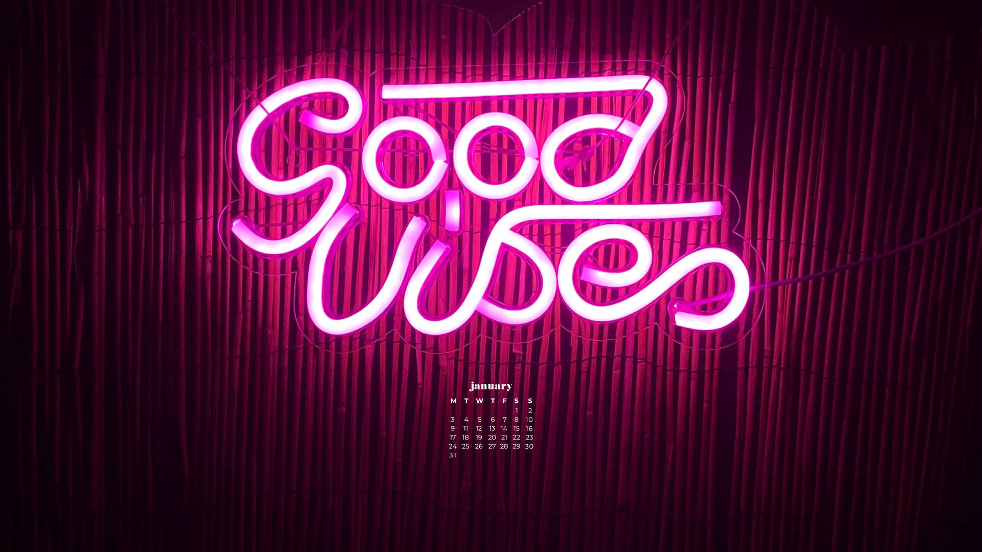 粉紅色霓虹燈牌寫著 Good Wishes 在竹牆上，附有一月日曆。