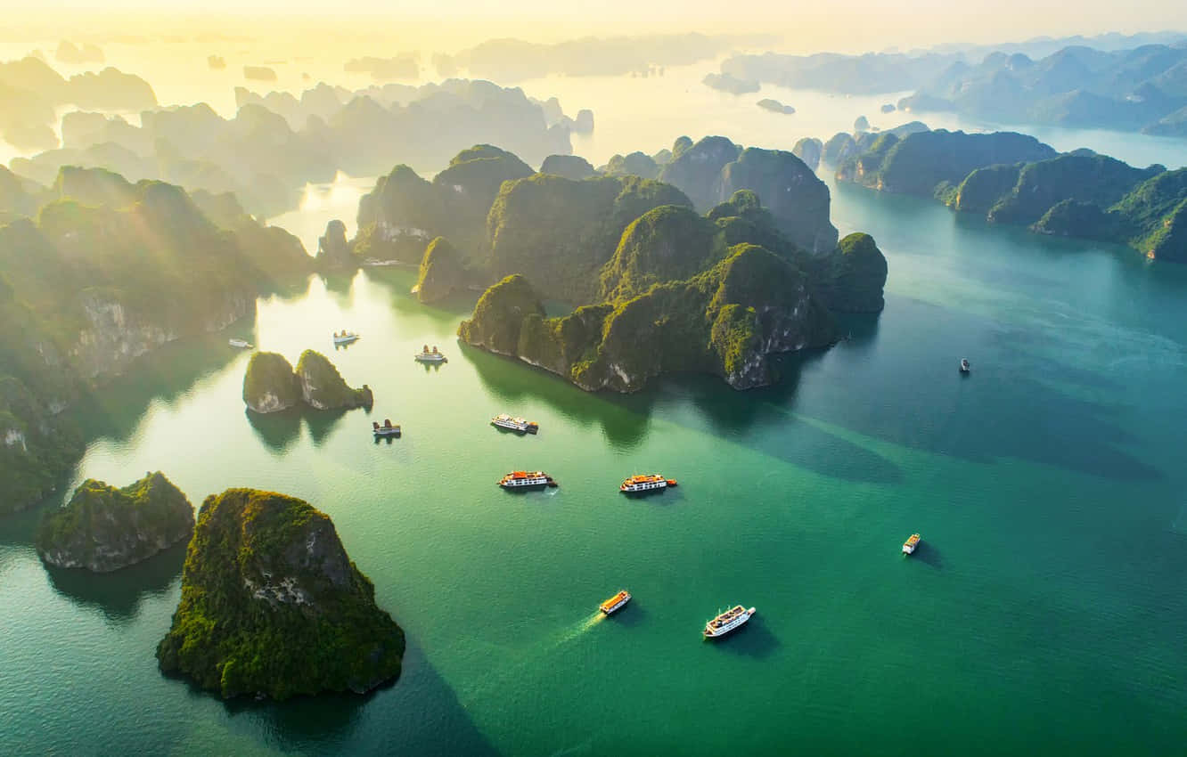日出時翠綠海水中的喀斯特島嶼和小船。