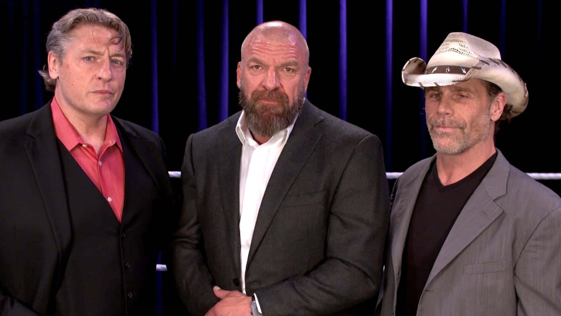 威廉·雷加爾與Triple H、肖恩·邁克爾斯 壁紙 — 三名身穿西裝的男子莊嚴地站在深藍色窗簾背景前，其中一人戴著牛仔帽。