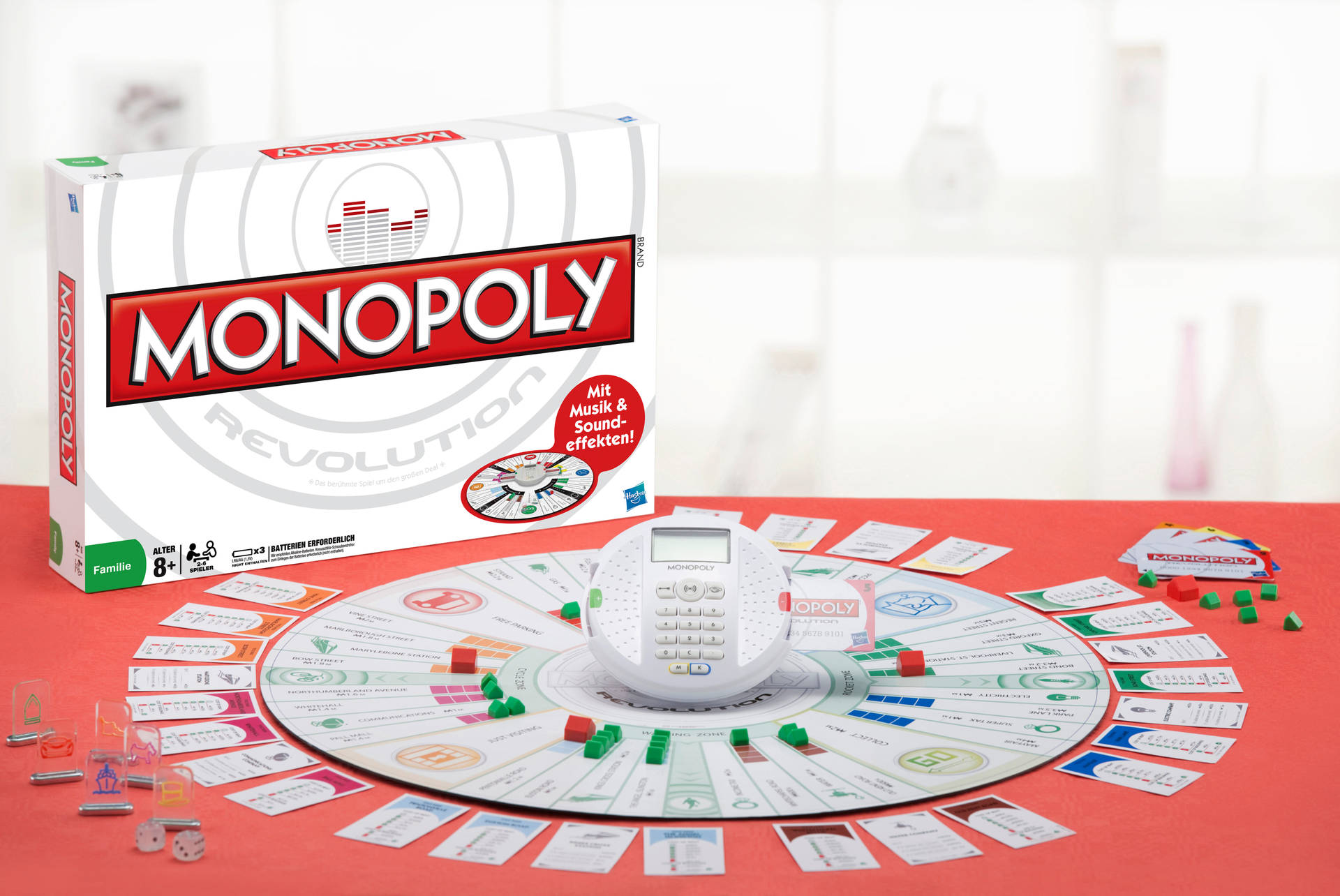 Monopoly Revolution 棋盤遊戲，附卡牌、籌碼和數位計時器，置於紅色桌子上。