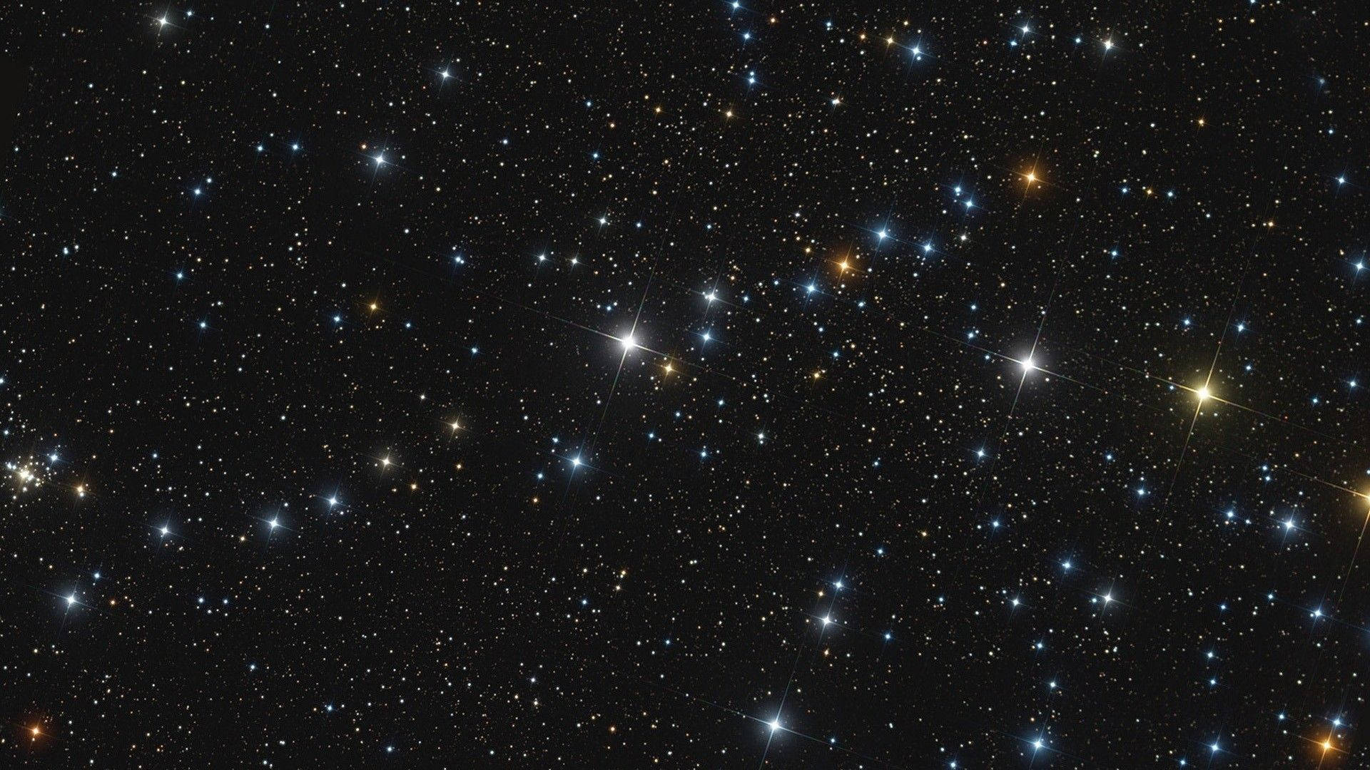 廣闊的星場，藍色和金色的星星點綴在黑色太空中