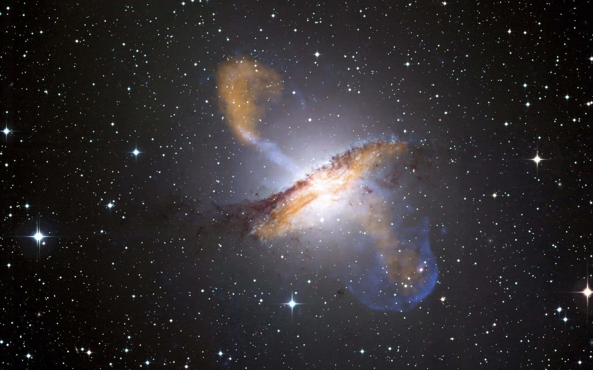 宇宙的壯麗之美 壁紙 — 一個令人驚嘆的螺旋星系，帶有發光的橙色和藍色旋臂，在佈滿明亮星星的星場中旋轉。