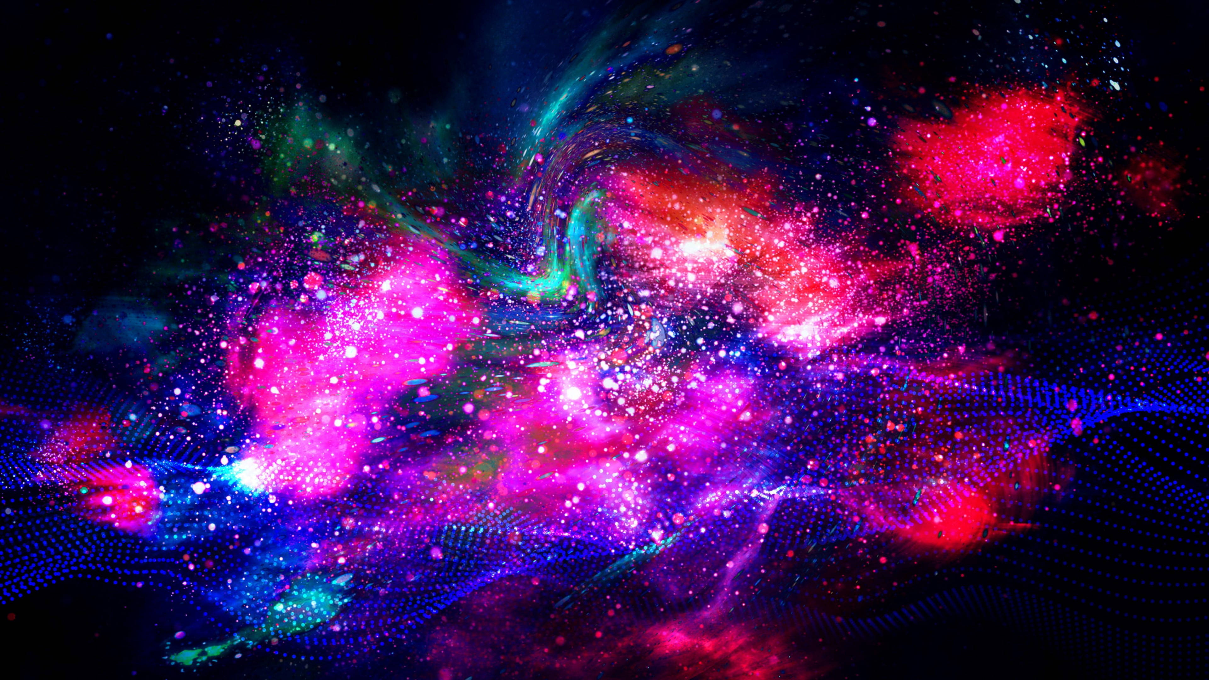 宇宙色彩爆發 壁紙 — 充滿活力的宇宙星雲在黑暗的數位太空背景中旋轉，帶有粉紅色、藍色和綠色的發光粒子。