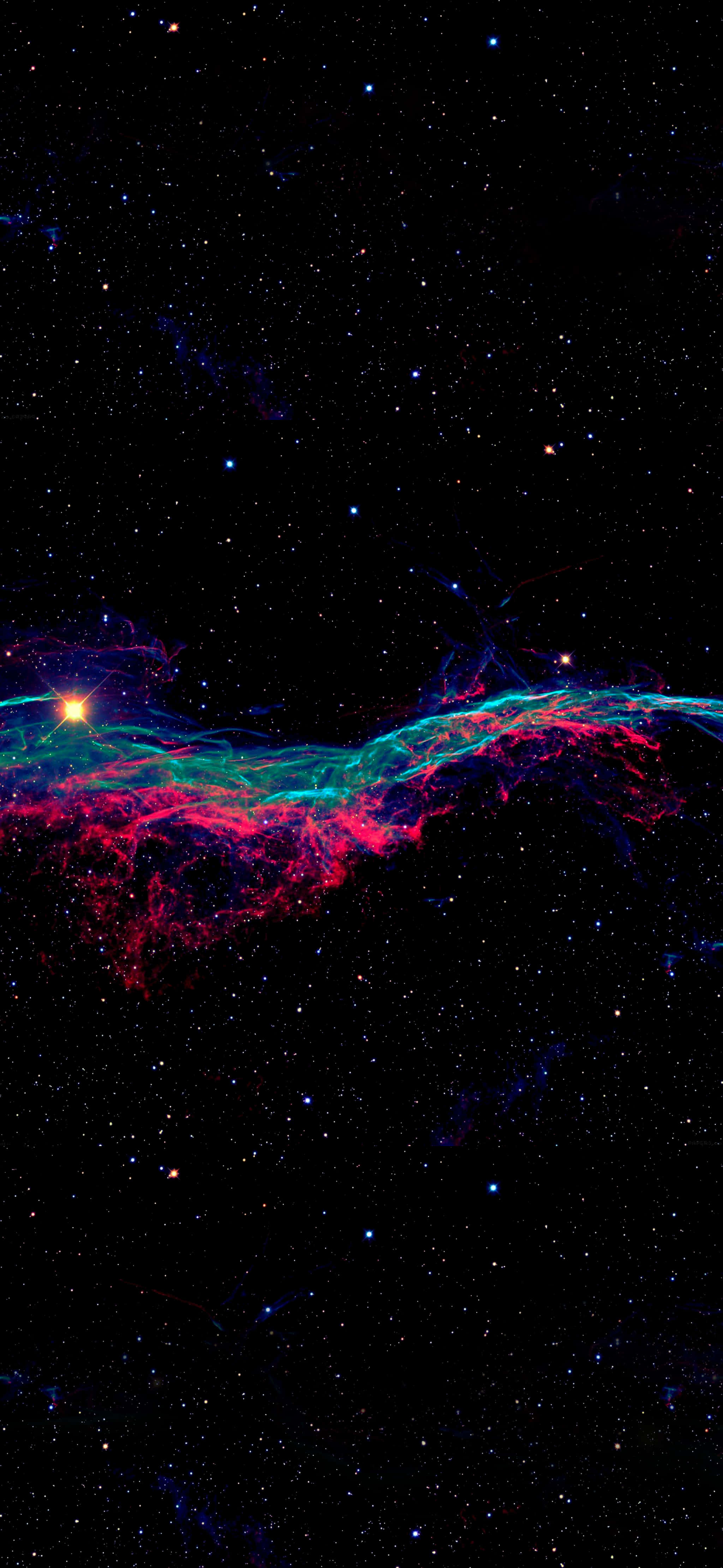 安卓OLED背景 壁紙 — 一個充滿活力的宇宙星雲，粉紅色和藍綠色的氣體旋轉著，延伸在佈滿星星的黑色虛空中。