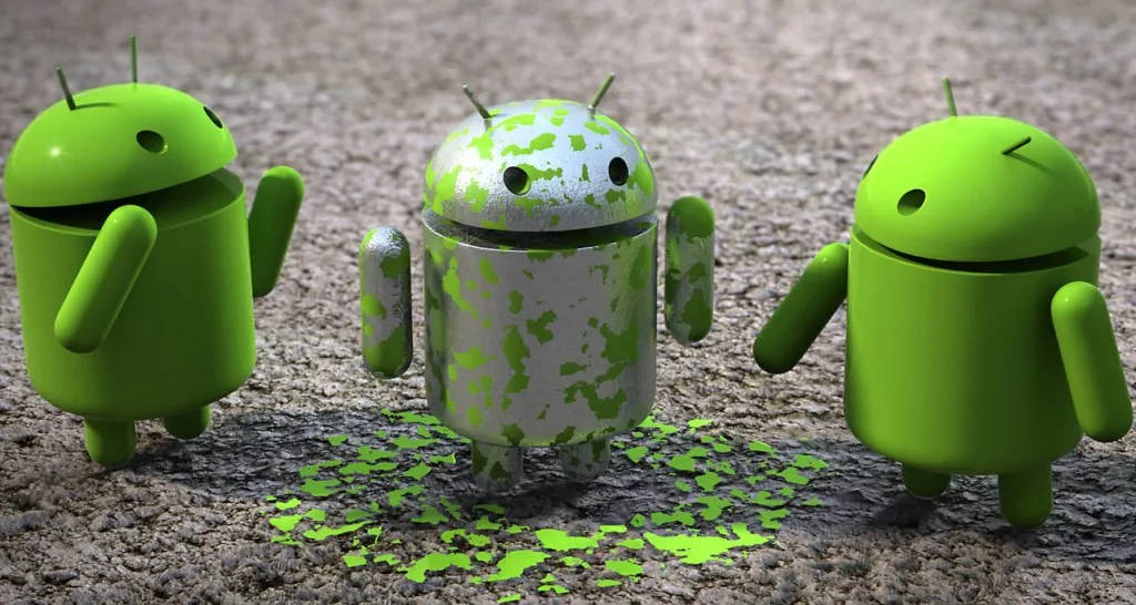 三個Android機械人公仔，一個在紋理地面上被綠色油漆濺到。